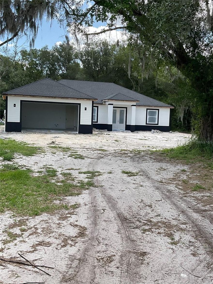 Under Construction. Welcome to your dream country retreat! This stunning new construction home features 4 spacious bedrooms, 2 beautifully designed bathrooms, and 9-ft ceilings throughout, perfectly situated on 2.5 acres of gorgeous, wooded land on the outskirts of Arcadia. Surrounded by mature trees, this property offers the ideal blend of privacy and peaceful living.

This home is currently under construction and is projected to be completed by the end of May—giving you the opportunity to secure your future home before it’s finished!

Step inside to discover an open and airy floor plan with high ceilings that create a bright and inviting atmosphere. Built with quality and efficiency in mind, this home includes hurricane-impact windows and doors, foam insulation, and durable porcelain tile flooring throughout the entire home.

The kitchen will be a true centerpiece, featuring a stylish two-tone design once completed, offering both function and modern appeal. Enjoy seamless indoor-outdoor living with beautiful French doors that lead to a large back lanai—perfect for relaxing, entertaining, or taking in the serene natural surroundings.

This home also boasts a very spacious 2-car garage, providing plenty of room for vehicles, storage, or a workshop area.

With plenty of space to spread out, this property offers endless possibilities, whether you’re looking to create your own private oasis, bring animals, or simply enjoy the tranquility of country living while still being just a short drive to town.

Don’t miss the opportunity to make this beautiful new construction home yours—schedule your private showing today!