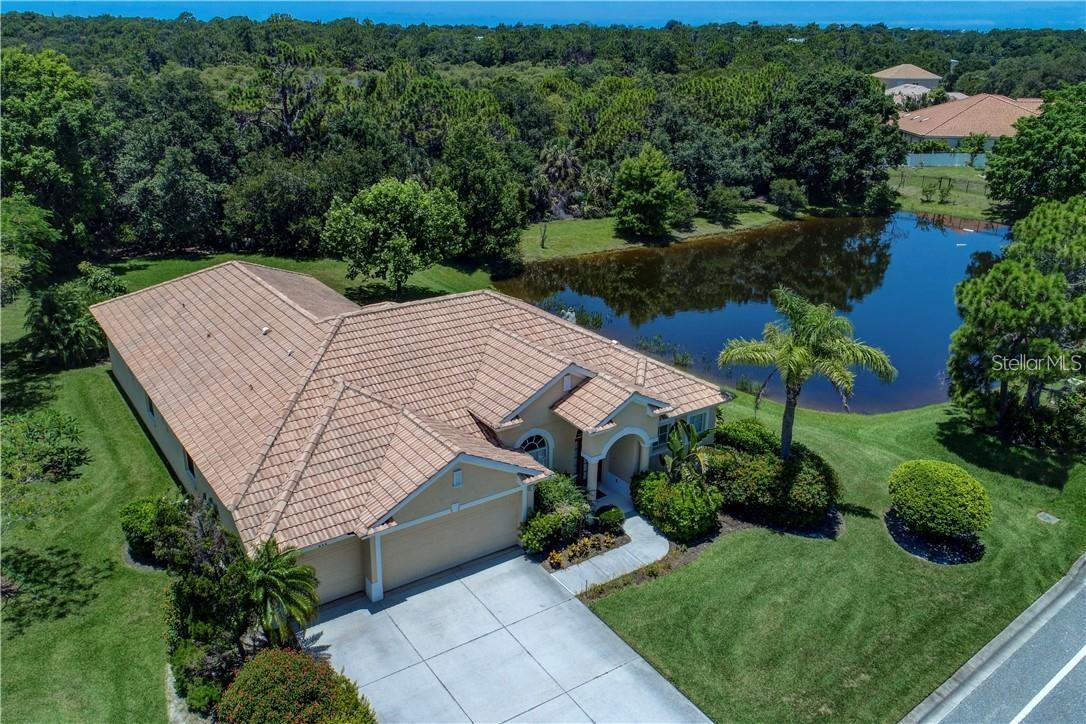 Built by Rutenberg Homes, this residence offers high tray ceilings and a smart, open layout. The formal living and family rooms, along with the en-suite primary bedroom, open to the lanai. The dining room features custom built-ins, two guest bedrooms share a bath, and a private in-law suite/office includes its own bath and lanai access. The kitchen, with newer appliances, a breakfast bar, and an eat-in nook, connects to the family room with an electric fireplace. The lot backs to a wooded preserve with a pond on one side. A heated community pool is just a 3-minute walk away. Additional features include a drilled well for sprinklers, exterior taps, a three-car garage with EV charger, and new central heating/AC (March 2025). Walk to Pine View School for the Gifted, close to the Legacy Trail, Gulf beaches, Oscar Scherer State Park, and boating. Optional Turnkey. Seller will consider all offers.