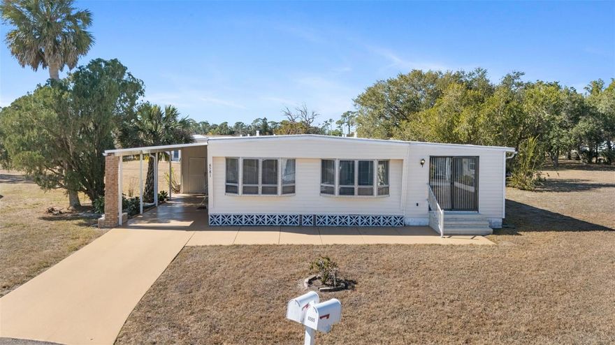 EVERY day feels like you're on VACATION when you live in HOLIDAY PARK! This INCREDIBLE 3 bedroom/3 bathroom home is an ideal seasonal or year-round residence. Enter the front door and enjoy an open and bright living space, accented with two large bay windows. The  home features updated vinyl plank flooring and laminate flooring.  A galley style kitchen loaded with cabinets and storage space leads to a dining area with a bay window. Three bedrooms and three bathrooms provide lots of space for guests or you can convert one into a hobby room or office. One of the most CHARMING features of this home is the extra large, enclosed and air-conditioned lanai. Fully protected from the heat and the elements, this light, bright room is an ideal spot for relaxing or socializing with guests. Another OUTSTANDING feature to this home is the OVERSIZED lot--offering lots of backyard space. 

Holiday Park offers abundant AMENITIES! The club house shared meeting spaces, a library, and a catering kitchen. Work out in the community FITNESS CENTER. Enjoy the pool during the hot summer months, and lie out and catch some rays on the large deck. There is an on-site laundry center with multiple washing machines, dryers, and folding tables. Holiday Park has special district designation and the annual $2340 fee is collected with your annual tax bill. 

DON'T WAIT! Call and schedule your viewing of this FANTASTIC home today!