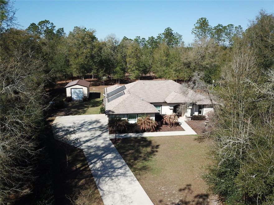 Tucked away in the back of Rainbow Springs Woodlands, this exceptionally well-maintained 3/2 split open floor plan offers peace, privacy and natural beauty on over an acre of wooded paradise.  Outdoor highlights feature a large 14x20 workshop steel building with electric and roll up door, oversized garage with 18’ door, spacious screened lanai with solar heated POOL with AUTO FILL and Overflow, as well as separate 5-person hot tub, perfect for relaxing.  Indoor features a chef inspired kitchen with quartz counters, soft close cabinets, GE Profile black stainless appliances, under cabinet lighting, wood look porcelain tile throughout, dual vanities with quartz counters in the primary bath as well as an oversized shower, and LED lighting throughout. 

Residents enjoy exclusive access to Rainbow River Park with a private beach, kayak launch, clubhouse with bar & grill, pool, fitness center, tennis courts and scenic walking trails.

Don’t miss this incredible MOVE IN READY dream home!