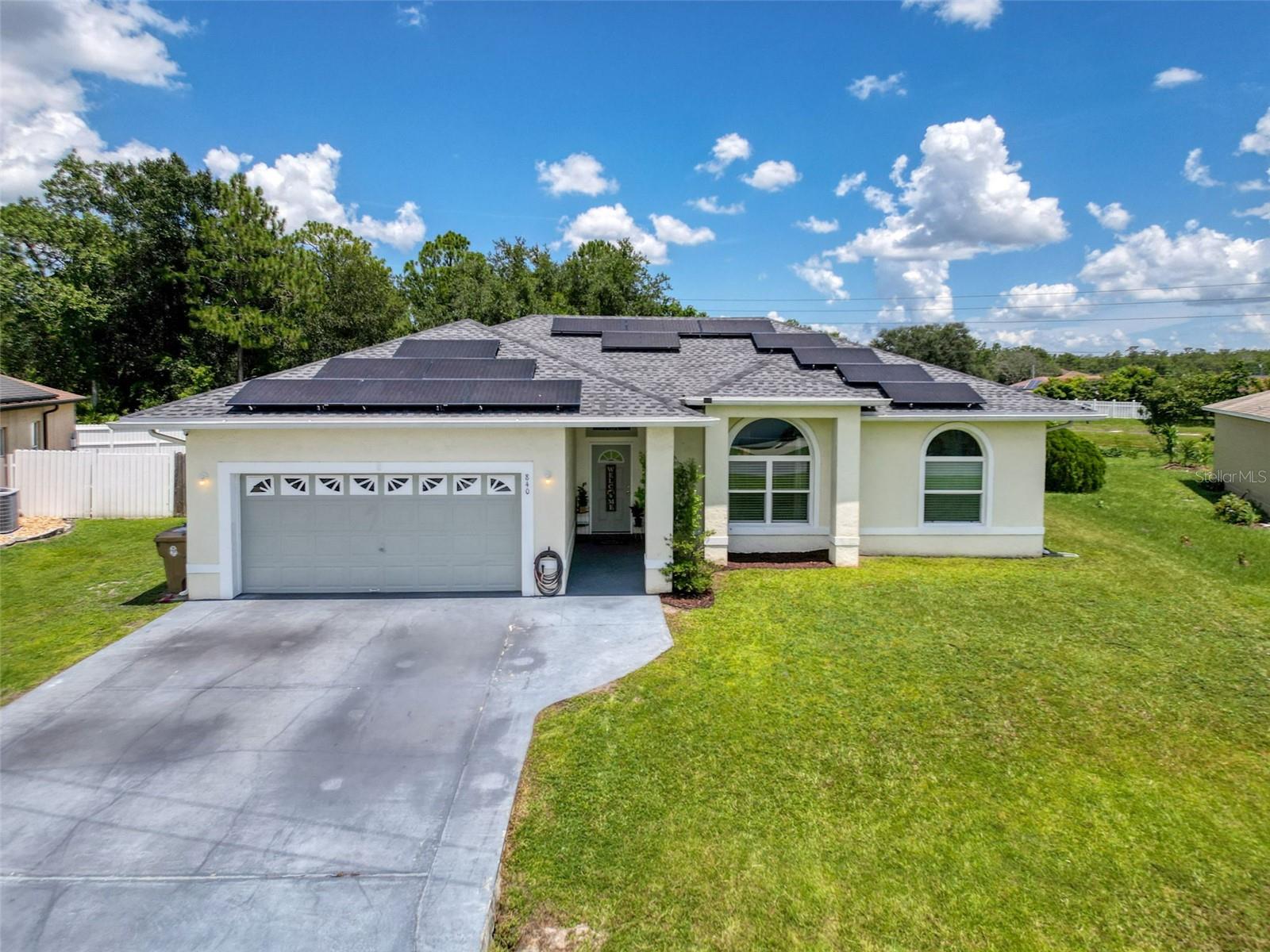 Welcome to this prime Poinciana location close to Poinciana Pkwy. A brand new roof was installed in July 2024 & the solar panels will be paid off at closing. Imagine the bragging rights when July’s peak summer electric bill was only $108 & every bill from January through June was just $33. Pride of ownership is evident from the moment you arrive & continues throughout this 3-bedroom, 2-bath home with a split/open floor plan. It sits on over a ¼ acre lot with a fenced yard. You’re immediately welcomed by an open-concept layout highlighted by built-in features & soaring ceilings. The living area has tile flooring that flows into the dining room & kitchen, where windows & sliding glass doors fill the space with natural light. The remodeled kitchen is a standout with wood cabinetry, generous counter space, a breakfast bar & a closet pantry. The primary bedroom offers laminate flooring, a walk-in closet & an en-suite bath with an updated dual sink vanity, walk-in shower & closet shelving. Two additional split bedrooms & a full guest bath complete the home’s layout.Step outside to a screened & covered patio with dual ceiling fans. The fenced yard includes a pool, shed & concrete pad with gazebo. A recent 4-point inspection shows the home passing all major components. The 2011 A/C received a new motor in 2023 & the water heater was replaced in 2021. This home is just 4.2 miles from the Poinciana Victory Pool & water park. Visit the Association of Poinciana Villages website to explore all the amenities offered to residents. Ask your Realtor for the helpful MLS attachments with even more reasons why this is a fantastic home & community to call your own.