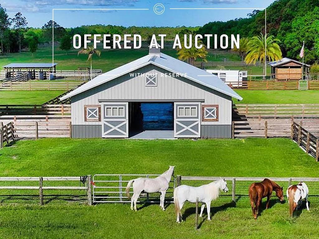 Auction Property. **LUXURY REAL ESTATE AUCTION on-site on Monday, May 12, 2025, at 11:00 AM. Previews begin Saturday, April 19th, and will run every Saturday & Sunday 1-4 until the auction. Private appointments are available; please call for details.** A property like this so RARELY comes available! This extraordinary, secluded estate on nearly 35 acres features a recently-completed new construction home and a world-class collection of outbuildings and features that will check all the boxes for any equestrian enthusiast. Ten acres of fenced and cross-fenced pastures surround the barn complex and an additional nine acres of pasture land feature field fencing and a pond. The newly built 72’x36’ main barn houses 6 stalls with padded and monolithic sealed rubber matting. The barn also features a large equipment/hay room, a feed/tack room, a kitchen, and a half bath. Two Florida-style barns and three shed-style barns provide an additional 12 stalls and an extra tack room. Overall, there is ample room to maneuver a horse trailer throughout the property, but you won’t need to as often with the ability to trail ride your own property! Outside of the pasture, the remaining twenty semi-wooded acres feature incredible landscaping, mature oak and cypress trees, private shell-lined nature trails, and a serene pond with fountain, waterfall, and adjacent seating area with firepit. Just beyond the gated main entrance to the property sits an impressive 47’ free-span bridge, built by nationally renowned York Bridge Builders. Crossing Corbit Creek, the bridge leads to the circular drive greeting the brand new, spectacularly built three bedroom, three bathroom main house with an open floor plan and soaring 12’ ceilings throughout. The eat-in kitchen, equipped with KitchenAid and GE Monogram appliances and bar seating, is light and bright as it looks out to a full wall of 10-foot sliding glass doors. There is also a hidden butler’s pantry complete with refrigerator, sink, and an abundance of storage space. The luxurious owner’s wing boasts an art gallery hallway, a large walk-in closet with custom built-ins, an owner’s washer and dryer for added convenience, and a separate sitting area/flex room which could serve as a studio, gym, nursery, etc. The en-suite bathroom offers dual water closets, a full-glass spa-style shower decorated with natural stone, a rainfall shower head, and LED lighting. An adjacent study includes dual built-in desks and custom shelving. In the garage, the air-conditioned exercise room is an ideal place for workouts and storing fitness equipment. On the pool deck, the lanai screen features 40’ Clear Span screening for a full view and appreciation of the live oaks and landscaping along the creek. The gorgeous saltwater pool and spa features a California entry, an autofill feature, and delightful fountains. The Lion Grill in the outdoor cooking station completes the package. This property is an ideal family and entertaining compound, with a separate guest house, RV hookups, and a large outdoor pavilion complete with a kitchen, bathroom, grill, and picnic area. There is ample space to come together as well as countless ways to retreat for privacy. Additional features of the property include 5 septic systems, 2 wells tied together and generator-ready, a 25’x45’ greenhouse with roll up sides, Pentair irrigation system, and water treatment system.