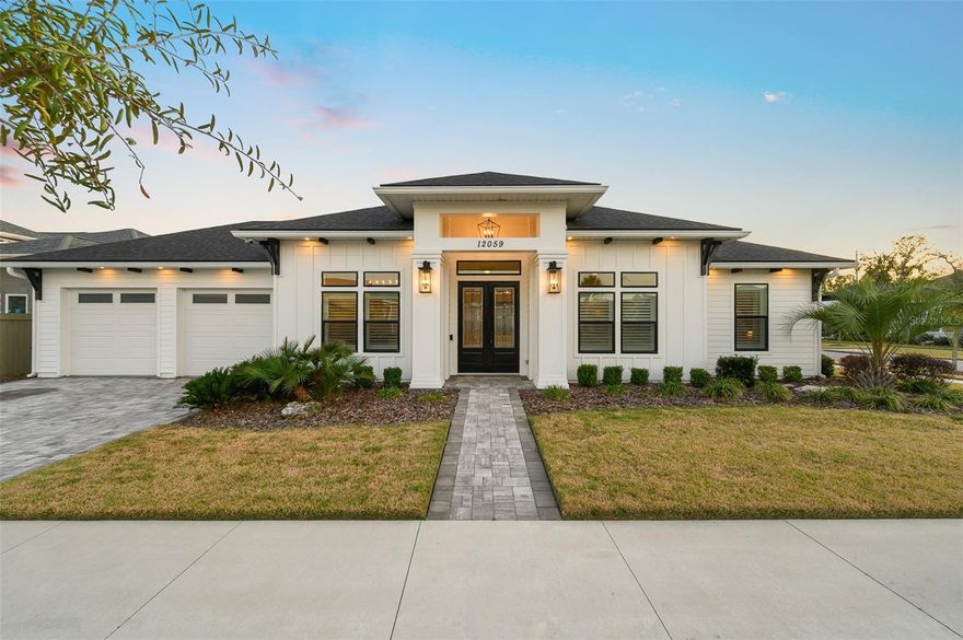 Nestled on a prime corner lot in Gloria's Way, this 3 Bedroom PLUS Study (could be 4th BR) POOL HOME was formerly the builder’s personal home. It offers an exquisite blend of architectural sophistication and resort-style living. The open-concept interior is defined by soaring 13-foot ceilings, stepped tray details, upgraded features throughout, modern design with painted stone and open shelving accents and rich hickory hardwood floors. At the heart of the home, the chef’s kitchen is a masterpiece featuring floor-to-ceiling cabinetry, quartz counters, Scotsman built in ice machine, and professional-grade KitchenAid appliances, complemented by a custom bar with a Thor beverage center and a walk-in pantry with butcher block shelving. The primary wing serves as a private sanctuary, boasting a spa-like bath with a 14-jet soaking tub and a massive closet with high-end custom built-ins. Step through the glass retractable sliding doors to an outdoor oasis where a stained cypress ceiling covers a summer kitchen equipped with a Blaze grill, motorized screens, overlooking a stunning 14x26 saltwater pool featuring fire-bowls, waterfalls and a sun shelf. The fully fenced and professionally landscaped grounds are completed by a paver fire pit area, a tankless gas water heater, full Cat 6 networking, full security system with new cameras and doorbell, ensuring every modern luxury is at your fingertips.