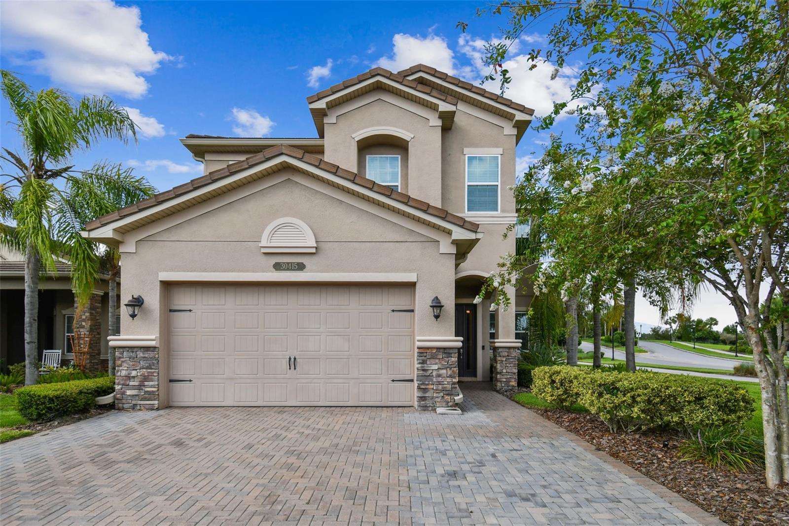 Stunning 5-Bedroom Home with Pond View in The Ridge at Wiregrass Ranch! Welcome to The Ridge at Wiregrass Ranch—Wesley Chapel’s premier luxury community! This elegant Conrad model by GL Homes offers nearly 3,400 sq ft of living space with 5 bedrooms, 4 bathrooms, a spacious bonus room, and a 2-car garage—all situated on a premium corner lot with a fully fenced yard and tranquil pond view. Step inside to soaring 10 ft ceilings and a bright formal living area, perfect for welcoming guests. The heart of the home is the open-concept kitchen and family room, ideal for entertaining. The chef’s kitchen features granite countertops, 42" wood cabinetry, stainless steel appliances, recessed lighting, and a large island. Sliding doors lead to a true outdoor oasis—enjoy a covered lanai, extended patio, and fully equipped outdoor kitchen, all overlooking peaceful water views. A full bedroom and bathroom are located on the main floor, perfect for guests or multi-generational living. Upstairs, a spacious bonus room offers endless flexibility—ideal for movie nights or a playroom. The luxurious primary suite includes dual walk-in closets and a spa-like bath with double vanities, soaking tub, and separate shower. Three additional upstairs bedrooms and two full bathrooms (including a Jack-and-Jill) provide ample space for the whole family. Living in The Ridge means access to world-class resort amenities: beach-entry pool with waterslide, lap pool, splash pad, fire pit, tennis & basketball courts, playgrounds, indoor sports complex, fitness center, clubhouse, and more. HOA includes full lawn care, landscaping, and exterior pest control for true maintenance-free living. Conveniently located near top-rated schools, I-75, The Shops at Wiregrass, Tampa Premium Outlets, and area hospitals—this home truly has it all. Schedule your private showing today and experience the best of Florida luxury living!