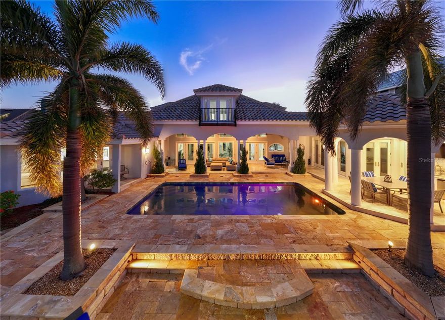 Stunning, Luxurious Waterfront Living & a Boater's Dream-All on One Level!  Welcome home to your Waterfront Oasis with this exquisite Mediterranean-style residence in the highly sought after Tierra Verde. Offering breathtaking views from multiple living areas, this home exudes the ambiance of a permanent vacation retreat. This luxurious one-level home boasts 3 bedrooms, 4 ½ baths, and a versatile Media Room/Den that can easily be transformed into a 4th bedroom. Designed for effortless living, the open-concept layout features a spacious Great Room with soaring vaulted ceilings, a cozy gas fireplace, and a wall of French doors and windows all with NEW high impact PGT glass that seamlessly open to your private outdoor paradise. Step outside to find a picturesque waterfront setting perfect for relaxation or entertaining—whether dining alfresco in the charming gazebo or watching boats glide by as gentle breezes surround you. With a sparkling pool and a multitude of sitting areas to choose from to host guests, this home offers waterfront living at its finest. The impressive gourmet kitchen is a chef’s dream, previously featured in Houzz Magazine it offers sleek Quartz “leather” textured countertops, Z Line 48” gloss blue double ovens, dual-fuel gas top, kettle faucet, Subzero refrigerator/freezer, dual Bosch dishwashers, two Kitchen Aid refrigerator drawers, Scotsman ice maker, Kitchen Aid convection microwave, warming drawer, and two high boy wine coolers—everything you need for a flawless culinary experience. Elegant Travertine floors flow seamlessly throughout the home, adding sophistication and timeless charm to each room. This residence has all NEW PGT high impact doors and windows, NEW Tile roof, NEW Seawall, and a NEW Circular brick driveway, NEW Epoxy flooring throughout the garage, New exterior Flat screen TV, ceiling fans and accent lights. The spacious Primary ensuite offers a tranquil retreat, featuring stunning water views, direct access to the heated pool and outdoor space perfect for lounging in the sun or shade, a luxurious Primary ensuite bath is a spa like retreat and features separate double vanities with granite counters, separate Soaking tub and enclosed dual shower and California style w/in closet. The outdoor kitchen features, Built in Gas Grill w/granite countertops w/ NEW icemaker and a separate built in table with granite top—all overlooking 106 feet of NEW seawall and the scenic Pass-A-Grille Channel. Boaters will appreciate the easy access to the Gulf of Mexico with no bridges, two boat lifts (1 lift up to 54,000 lbs. & 1 lift fit for 2 Wave Runners), and a generous 500 sq ft dock area, perfect for water enthusiasts. For car enthusiasts, this home also includes a 4-car garage (NEW epoxy flooring) with the option of converting one bay into a gym, offering ample space for your collection or personal fitness. Located just minutes from downtown St. Petersburg with easy access to the Interstate and only a 30-minute drive to Tampa International Airport. Fort DeSoto Park, and local beaches, this home truly represents the best of coastal living. Don’t miss your chance to make this Stunning Waterfront dream home a reality and schedule your appointment today.
