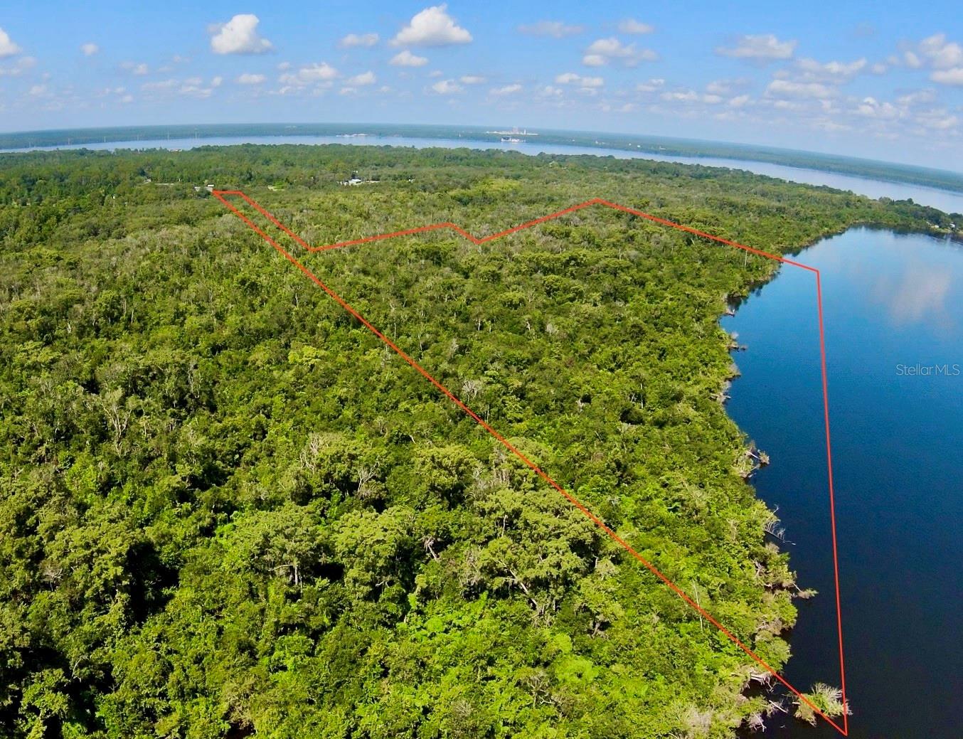Discover a rare opportunity to own approximately 50 acres of pristine, undeveloped land along the scenic St. Johns River in East Palatka. This expansive property offers breathtaking river frontage with stunning water views and endless potential for your vision. Whether you dream of creating a private estate, developing a waterfront retreat, or investing in future growth, this land provides a blank canvas surrounded by natural beauty and tranquility. Conveniently located with easy access to nearby towns and amenities, yet tucked away for privacy, this is your chance to own a remarkable piece of Old Florida along one of the state's most iconic rivers