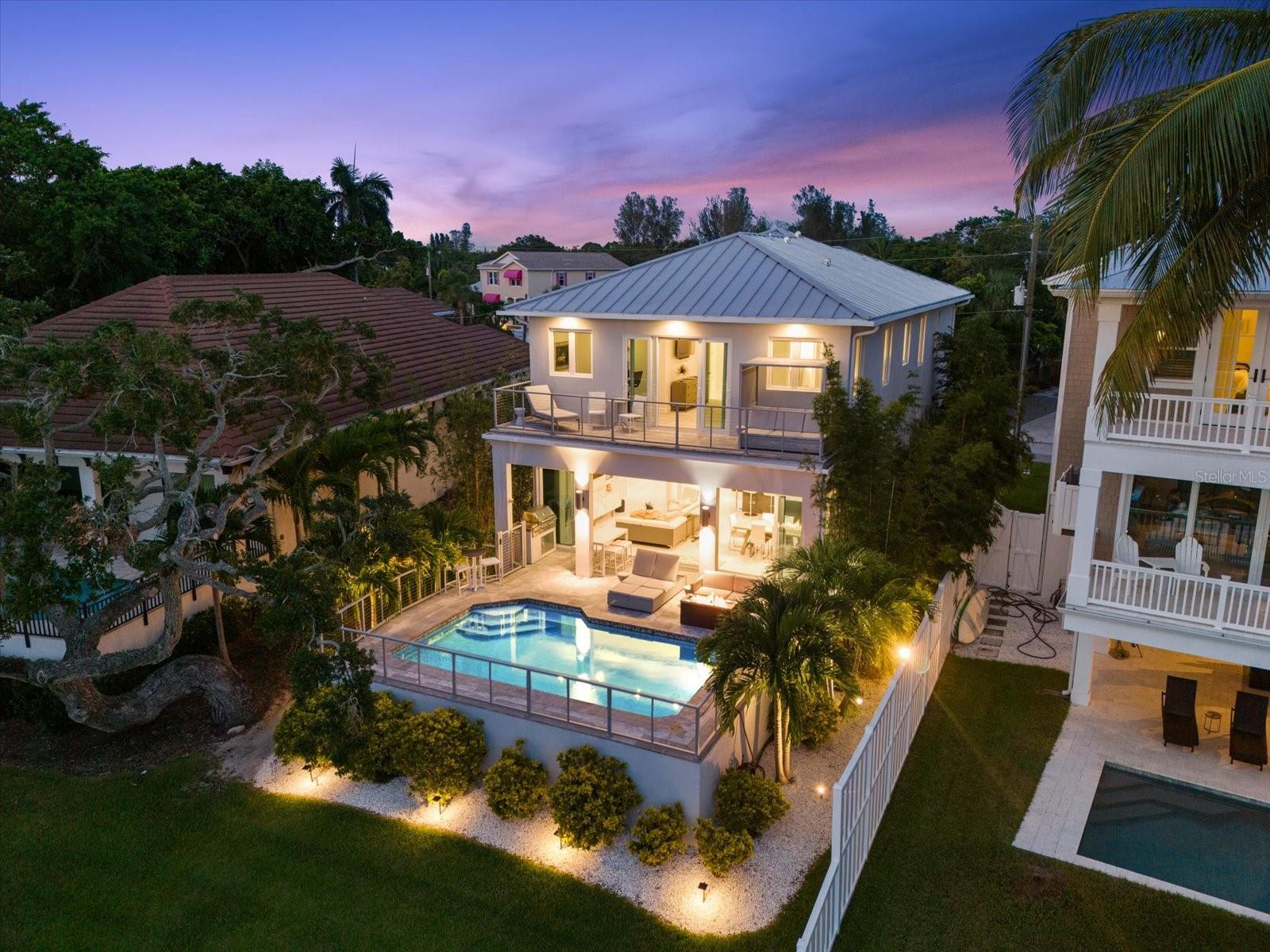 Come live the good life on Siesta Key in this spectacular Grand Canal- front home with water views, boat dock, bay access &Â gorgeous salt pool with travertine decking & custom summer kitchen. Casual elegance is exuded in every room of this 3 BR, 3.5 BA home, from the 1200 sq. ft. sprawling European style open kitchen to the full wall of glass sliders opening to the expansive outdoor living space. The main level of this 2019 custom home boasts an oversized entry foyer, a light and bright open kitchen flowing into the living area, sliders to the open pool with cable wire railing and built-in summer kitchen. The second level of the home features an extraordinary primary suite with an outdoor sitting area and covered balcony with views of the pool and Grand Canal. Enjoy a large soaking tub and spacious shower in the primary bath and an expansive primary closet. Two additional en suite guest bedrooms and a laundry room round out the second floor living areas. NO HOA Fees is an added plus! Highlights of this home include hurricane impact windows/doors, elevator with three stops- garage, main and top levels, Tesla charging station, automated custom European window treatments, central vacuum system, and new 10,000 lb. boat lift and dock (built to fit a 27' boat), oversized two car garage, balconies at front and back of the home, etc. Just minutes from the intracoastal waterway, Gulf of Mexico, and Siesta Key village! Siesta Key is proud to provide the best coastal lifestyle possible - island living, breath-taking sunsets, boating and award winning beaches are at your doorstep!