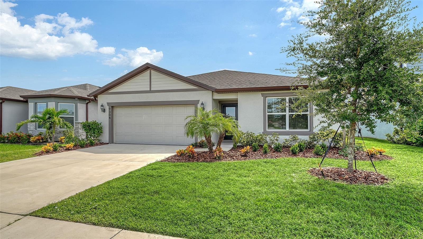 FORMER BUILDER MODEL HOME ALERT! North River Ranch house with 1,849 sq ft, 4 bedrooms, 2 baths, and a large 2 car garage on a great lot with lake views. The kitchen is bright and airy with stainless steel appliances, tile backsplash, hardwood cabinetry, a large pantry, granite countertops, and a large kitchen island with breakfast bar and space for bar stools. The Hanover model has an open floor plan which is perfect for entertaining. The primary suite has a gorgeous shiplap accent wall, walk-in closet and en-suite bath which features dual sinks and a walk-in shower. This split floor plan has three spacious bedrooms and bath on one side of the home allowing for privacy. Open the sliding doors to the private, screened lanai and enjoy the lake views. Separate laundry room equipped with a full size washer and dryer. Your furry friends will love this Pet friendly neighborhood with a 2.5 acre dog park. Brightwood at North River Ranch offers the best in Florida living with a 4,100 square foot clubhouse, a resort style pool, state of the art fitness center, a game room and a firepit area with tables and chairs. There are multiple clubhouses and outdoor fitness stations throughout the community, soccer, football fields, frisbee, cornhole, along with over 20 miles of nature trails and playgrounds for all ages. The Camp creek clubhouse offers a cafe kiosk, 2 waterslides, zero gravity pool entry, and plenty of outdoor seating, and a fire pit. The outpost building has a pool table, ping pong, and other games. Let's not forget the ever popular pickleball courts, bike pump park, and outdoor fitness stations. North River Ranch has loads of planned community events like Farmers Markets with fresh local produce and fun events like Food Truck Fridays and more! A village center is planned with full medical center and shops at your fingertips. The brand new Harvey K-8 school campus was just completed and talk about convenience, it is actually part of the community. Just minutes away from I-75 and 275 with easy access to St. Pete, Tampa, Sarasota, and Bradenton. Don't wait, this home won't last long. Call today for a showing.