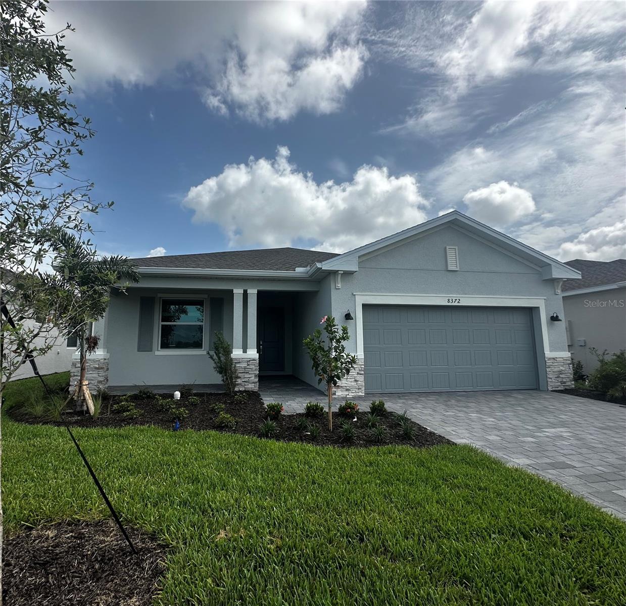 Enjoy maintenance-free living in this beautifully designed, newly built home located in a gated, master-planned community just 6 miles from the beach and in an X flood zone. This 3-bedroom, 3-bathroom home with a 2-car garage offers serene water views and resort-style amenities, including a community pool, fitness center, playground, clubhouse, and pickleball courts. The open-concept layout features neutral tile flooring, white cabinetry, quartz countertops, and impact windows throughout. The spacious kitchen includes a large island and walk-in pantry, perfect for everyday living and entertaining. The split-bedroom floor plan offers privacy, with a luxurious primary suite featuring a large walk-in shower and oversized closet. Bedroom two includes its own en suite bath—ideal for guests or multi-generational living. Enjoy the outdoors from the screened-in, pavered lanai overlooking peaceful water views and local wildlife. Complete with a refrigerator, washer, and dryer, this home is truly move-in ready. Lawn care included for effortless living. Don’t miss the opportunity to make this exceptional coastal retreat your new home!