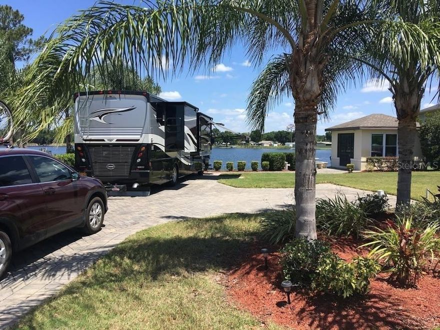 Welcome to Florida luxury living at 714 Meandering Way in sought-after Mt Olive Shores North, a premier 55+ RV community in Polk City.

Come and park your Class A RV on this beautiful lakefront RV pad and enclosed pavilion overlooking the serene and peaceful Clearwater Lake. There is lots of room for your RV plus cars. Enjoy all the great activities in this community while enjoying a quiet and peaceful country lifestyle. Community has two clubhouses, pools, spas, tennis courts, fitness center, laundry facility, 24-hour gated guarded security and so much more. 10,066 sq,ft. Pet Friendly, 35 minutes to Disney; 45 minutes to Orlando or Tampa.