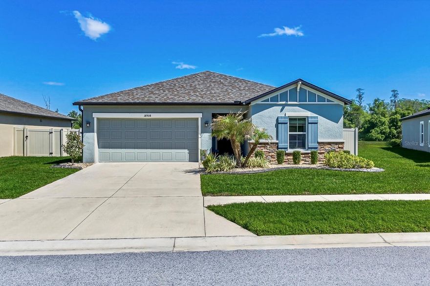 A RARE FIND – POND & CONSERVATION VIEW POOL HOME IN TALAVERA! Welcome to this sensational M/I Homes Ventura “C” model, built in 2020 and ideally situated on a premium fully fenced homesite with breathtaking pond and conservation views and no direct rear neighbors. This pristinely maintained 3-bedroom home shows like a model and features an open-concept layout with ash-blonde wood-look luxury vinyl plank flooring throughout the main living areas. The gourmet kitchen offers granite countertops, 42” upper cabinets with crown molding, shaker-style cabinetry, modern pendant lighting, stainless steel appliances including new refrigerator -2026, a large eat-in island, closet pantry, and glass backsplash, along with an upgraded single-basin sink and faucet. The spacious primary suite overlooks serene conservation views and includes a walk-in closet and en-suite bath with glass shower enclosure, granite vanity, and updated matte fixtures; the bedroom also features new carpet (March 2026) with a 5-year warranty. Additional upgrades include luxury vinyl plank flooring, neutral paint throughout, a custom stone feature fireplace wall in the living room, and an enhanced laundry room with added cabinetry and barn door addition including tile flooring and tile accent wall, and bedroom 2 also features an accent walls and currently utilized as a home gym as well as overhead storage mount in garage.  Step outside to your private backyard oasis featuring a saltwater pool with sun shelf and bubbler, a screened trussed lanai, additional exterior outlets, extended paver patio, and beautifully landscaped yard with rock, curbing accent, and full fencing on nearly 1/5 acre. Exterior improvements include gutters, concrete curbing in the front and back, irrigation system in both front and back, along with a stone-accent exterior and grand covered front trussed entry. Located in the highly desirable Talavera community, residents enjoy resort-style amenities including a zero entry pool, clubhouse, splash pad, cabanas, playground, basketball and tennis courts, and convenient access to Tampa, major highways, top-rated schools, shopping, dining, and beaches. This home offers the perfect blend of luxury, privacy, and lifestyle—schedule your showing today!