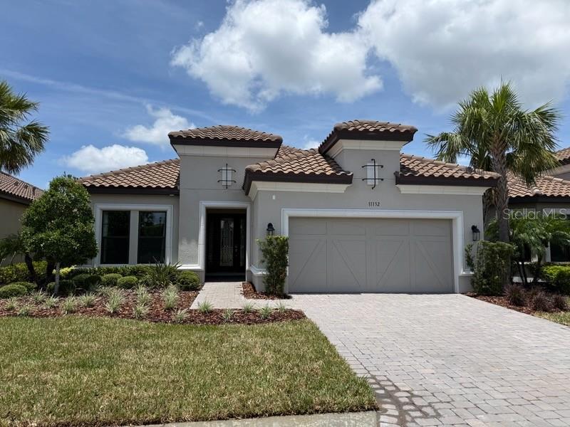 Welcome to your dream home—a stunning three-bedroom, three-bathroom pool residence situated in the resort-style community of Artisan Lakes at Esplanade. This property, formerly a model home, boasts numerous designer touches and elegant finishes, making it a must-see. Spanning over 2,200 square feet, this spacious property greets you with a welcoming foyer that leads into the dining area and a generous great room featuring decorative molding truly giving a refined accent to the walls. You'll fall in love with the gourmet kitchen, which offers ample counter space and cabinetry, built-in oven, gas cooktop range, pantry, stylish backsplash, and a breakfast bar for those casual meals. For those working from home or studying, the private study/office provides an ideal setting to accomplish your tasks. When it’s time to unwind, retreat to the primary suite, which exudes elegance with its tray ceiling, bay window, and an ensuite bathroom featuring dual sinks, walk-in shower, and spacious walk-in closet. The home also includes two additional generously sized bedrooms, one of which has its own ensuite bathroom. The laundry room is thoughtfully designed to help keep you organized, complete with built-in cabinetry, counters and sink. Now, are you ready to discover your outdoor oasis? Step through the sliding glass doors into the backyard you've always dreamed of. The covered lanai, featuring an extended section, offers ample space for entertaining, complete with a built-in fireplace and outdoor kitchen. Enjoy a refreshing dip in the sparkling blue pool or relax in the spa, all within a screened enclosure for added comfort and enjoyment. Esplanade at Artisan Lakes truly embodies resort-style living, offering a wealth of amenities which is located conveniently across the street. Enjoy a refreshing dip in the heated resort-style pool, engage in a game of tennis or pickleball, or take your dog to the pet park for a spirited game of fetch. You can also unwind with friends around the fire pit or attend community events organized by a full-time Lifestyle Manager. While relishing the exceptional array of resort-style amenities on-site, you'll also have easy access to nearby shopping, dining, medical care, outdoor recreation,beaches, nature reserves, and more. Don't miss out on this gorgeous home!