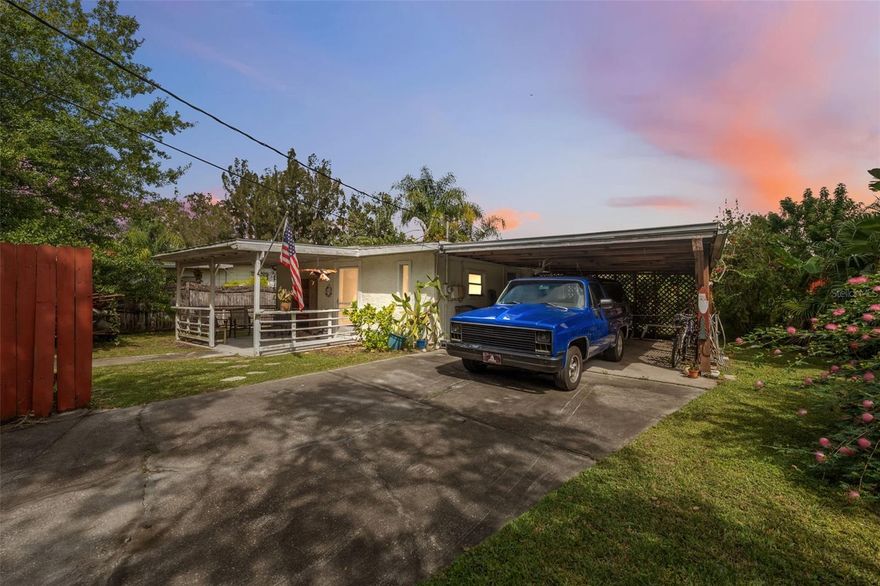 Tucked along the gentle flow of the Anclote River, this single-story waterfront home perfectly captures Florida living. The yard is framed by mature trees, while the covered two-car carport and covered front porch provide shade and places to sit outside and enjoy. Inside, the home opens to a foyer with tile flooring and wainscoting, leading seamlessly into an open-concept living space. The galley-style kitchen features light cabinetry with wood trim, crown molding, tiled counters and backsplash, and a ceiling fan that enhances comfort while cooking. Just beyond, the dining area flows naturally into the spacious living room, where large windows fill the space with sunlight and offer peaceful views of the surrounding greenery and river. Double glass doors opening outward connect to an enclosed rear porch that overlooks the water, providing a perfect spot to enjoy morning coffee or unwind in the evening as the sun sets over the river. The primary bedroom has an ensuite bathroom that has a tub/shower combo, and tiled walls and floors. The second bedroom is ideal for guests, an office, or a hobby room. Outside, the backyard opens to a beautiful waterfront view, where a pavered walkway leads down to the river’s edge surrounded by lush landscaping and the sounds of nature. The screened porch and open lawn provide ideal spaces for relaxation, gardening, or weekend gatherings. Whether you’re fishing from the shore, enjoying the gentle river breeze, or simply taking in the scenery, this home offers a lifestyle of peaceful simplicity. Conveniently located near Anclote River Park, where you can launch a boat or enjoy a picnic by the water; Key Vista Nature Park, known for its walking trails and birdwatching; and the Tarpon Springs Sponge Docks, a local favorite for waterfront dining and boutique shopping—this property brings together nature, comfort, and accessibility in one timeless riverside retreat.