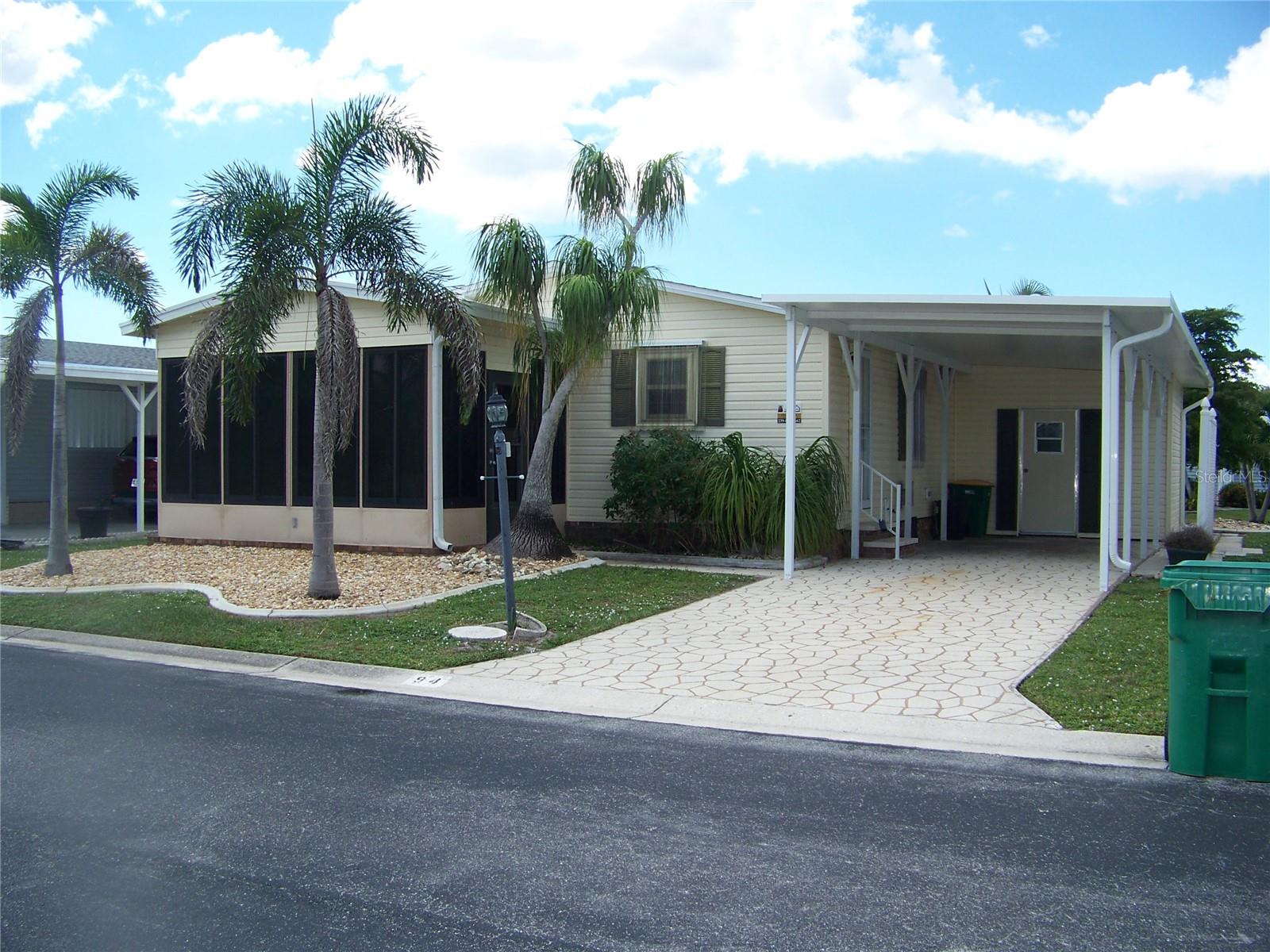 Welcome to BEAUTIFUL, GATED, BURNT STORE COLONY where the residents are friendly, there is a huge array of amenities, and they welcome your loving fur babies! Don't waste any time in visiting this quaint, adorable, updated 2 bedroom, 1.5 bath home (shower or tub can be reinstalled, plumbing is there) that is completely furnished with turn-key items and... the land share valued at $32,000! You will be amazed at how stunning this home is, with very tasteful decor & furniture! The kitchen shows off Corian counters with custom hardware, separate breakfast area w/bar stools, an amazing amount of real wood cabinets/drawers/closets & even a small China cabinet! The sinks are undermount with a window to let natural sunlight in! There is a dining area & combo living room that is very nice in size leading to an all-weather lanai that has A/C & plenty of windows ready for you to enjoy your morning cup of coffee! Master is beautiful in size & decor & has a walk-in CEDAR closet with adjoining bathroom with wainscoting/chair rail. Guest is ample in size & ready for your favorite guest! The exterior has a large shed with a vinyl floor, newer washer & dryer, cabinets & overhead storage, water heater & MANIBLOCK plumbing! There is a patio in the rear adorned with many concrete curbed gardens for outside entertainment. New items are Shingle roof with fascia & soffits, carport with extra hurricane supports & all-weather lanai roof has been resealed for added protection. Extras include downspouts & gutters, lots of gardens on all sides, stamped driveway, hurricane shutters, laminate wood-like flooring, knockdown finished walls throughout, cathedral ceilings, 6 panel doors and MORE! Home comes with all turn-key items & EVERYTHING YOU SEE!!! Make an appointment to see this stunning little piece of paradise before it is gone, you will be glad you did!!!