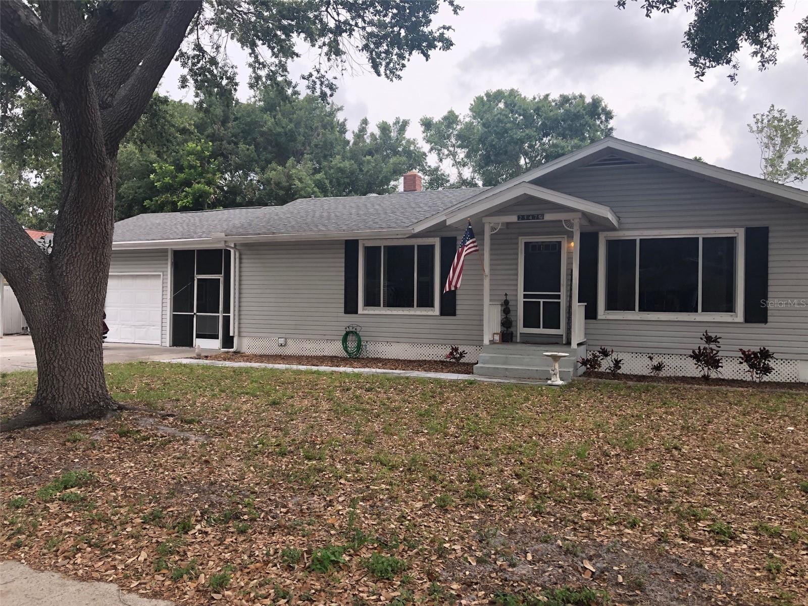 BIG PRICE REDUCTION! Yes! This home sits on TWO Buildable lots (50 x 106') each on a lovely tree lined street! Just minutes from Memorial Hospital and Downtown Sarasota. Currently owner occupied. This 2 Bedroom 2 Bath plus Den home is an excellent investor opportunity. New roof in 2022. 1588 SF of airconditioned space, plus screened lanai, single garage, plus single carport. Enjoy the Old-World charm of natural oak floors in Livingroom, dining room and master bedroom. Home sits on higher elevation with excellent drainage, has never experienced any flooding and does not require flood insurance. Rustic Lodge has no HOA fees. Electrical power lines are scheduled to be buried under ground, permits have been signed.