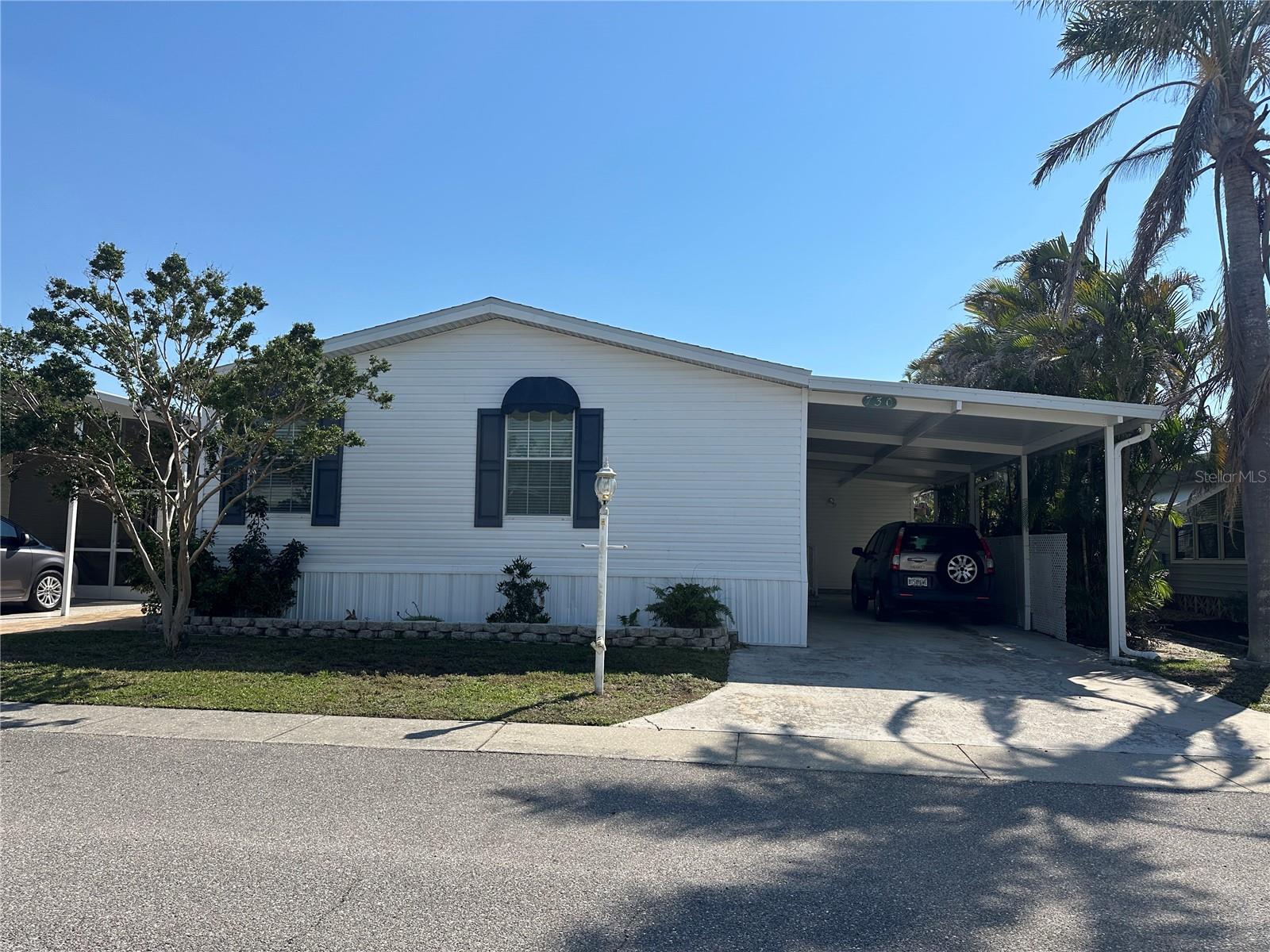 This two bedroom, two bathroom doublewide is move in ready! One of the newer homes in the community, this 2009 home has everything you need whether you are looking for a fulltime residence or seasonal getaway. The bright, open floor plan is perfect for entertaining. With over 1400 square feet, there is room for everyone! The kitchen has a breakfast bar an is open to the living and dining rooms. The convenient indoor laundry room includes a sink and storage. The large master bedroom has lots of natural light and an ensuite bathroom complete with a soaking tub and walk in shower. The home is dog friendly and sits on the perimeter of the community. No neighbors behind! There is an open porch in the private back yard as well. Located in Japanese Gardens, you are close to downtown Venice, Englewood, and Wellen Park and less than 2 miles to Manasota Beach! Japanese Gardens is an active 55+ community with many amenities including pickleball, bocce, shuffleboard, a community pool and hot tub, and a clubhouse where many activities take place.