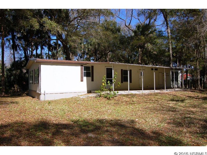 Located on 1 Acre of land and shaded by mature Live Oaks, this quaint 3 bedroom 2 bath Doublewide Mobile Home offers the privacy of a rural setting but the convenience of nearby city creature comforts. This home is a must see featuring wood laminate floors throughout, eat-in-kitchen, and a lot of cabinet space.  Other features include a built in china cabinet, outdoor shed,and circular driveway.  This home is clean, and move in ready. ;Water: City