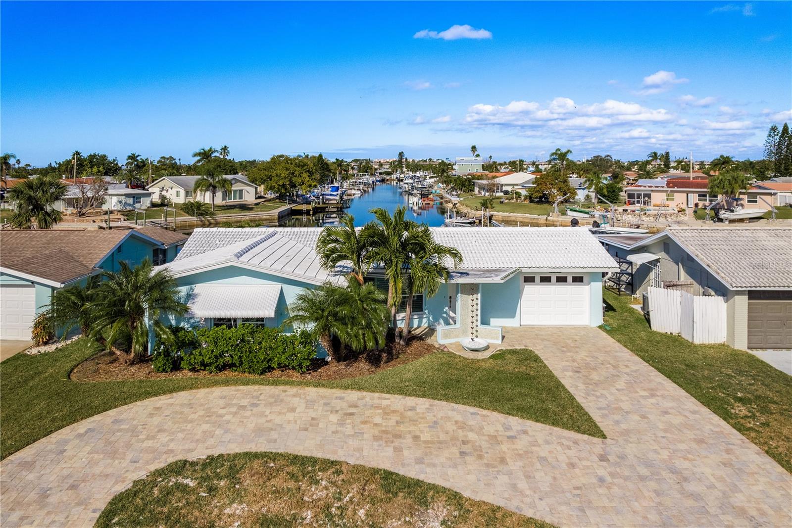 Come enjoy the Tropical Lifestyle in this newly renovated 3-bedroom, 2-bath home featuring 66 feet of waterfrontage with 10,000 lb. lift, huge 24 x 24 fixed dock with composite decking, convenient catwalk on the side of the lift, and brand-new floating dock. Situated on the deep sailboat-friendly South Channel with quick, easy, direct and unobstructed access to the open Gulf waters! Located in the highly sought-after community of Gulf Harbors. This home offers a great 3-way split-floor plan boasting a spacious living room with built in electric fireplace. The kitchen features solid wood cabinets, quartz countertops, stainless steel appliances, built-in desk area and large breakfast bar serving into the family room. The large family room features hurricane-grade sliding doors leading out to the large Travertine paver deck and offers beautiful and expansive water views. Off one end of the family room is the large primary suite which also offers wonderful water views, sitting/office area, huge walk-in closet and private primary bath with step-in shower. Off the other end of the family room is one of the 2 guest bedrooms with water views and its own access to the garage. The other guest bedroom located in the front of the home is gracious in size and has a large walk-in closet. Both guest bedrooms are served by a full guest bathroom. The home offers Travertine tile and Plantation Shutters throughout. The huge Travertine paver deck in the backyard is a perfect place to entertain your envious guests and enjoy the cool gulf breezes and has a built-in gas fire pit! The large paver circular drive allows for plenty of parking. This home has been completely replumbed, new electrical throughout, all drywall has been replaced from top to bottom. New HVAC system, duct work approximately 5 years old. This home is ready for you & your boat(s) to start enjoying the sandy beaches of nearby tropical islands! Excellent fishing, diving, water sports, shelling, island exploring, and more all right outside your door! Gulf Harbors is a golf cart friendly community and has an optional association that offers 2 boat ramps & other amenities. You also have the option to join the Gulf Harbors members-only private sandy beach overlooking the beautiful Gulf and Anclote Key offering cabanas & grills. Downtown New Port Richey, just a short drive away is lively and quaint with many restaurants, bars, shops, and Sims Park where you can enjoy one of the many special events and outdoor concerts throughout the year or stroll along the beautiful riverwalk along the Cottee River. Schedule your viewing today!