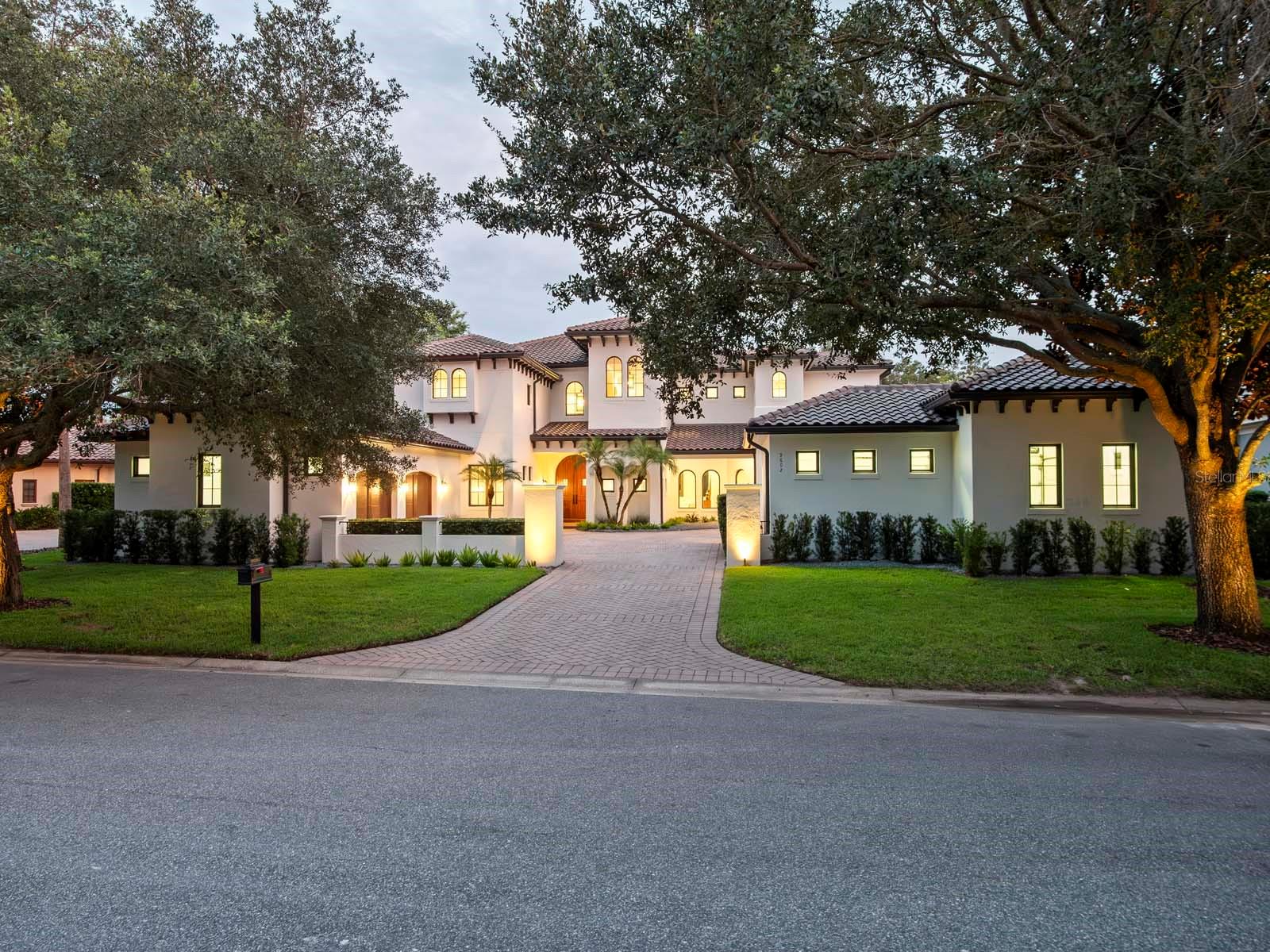 One or more photo(s) has been virtually staged. Nestled along the 12th fairway of Lake Nona Golf & Country Club's famed championship golf course, stunning panoramic fairway and water views provide the backdrop for this gorgeous estate within one of Central Florida’s most sought-after private communities. Originally built in a Mediterranean style, the residence has just undergone a comprehensive renovation by Akers Custom Homes, featuring an expertly reimagined floor plan, a new epicurean kitchen, remodeled bathrooms throughout, the addition of a second-floor laundry suite, and a fifth private ensuite bedroom. The exterior received a new roof, fresh exterior paint, Sierra Pacific windows and doors, and a newly designed saltwater pool and spa.
Custom double doors open to the home’s welcoming foyer, which introduces the thoughtful floor plan where formal and casual living spaces are enhanced by natural light and golf course views. The elevated interior design strikes the perfect balance of sophistication and warmth with new European white oak hardwood flooring and custom cabinetry throughout, and Lutron lighting integration for intuitive whole-home control. The chef’s kitchen showcases an all-new Viking appliance suite, including a 48” dual-fuel range with six burners, griddle, and double ovens, a 48” built-in refrigerator, professional dishwasher, and matching hood. A center island with Kohler prep sink, a walk-in pantry and a breakfast nook complete the space.
The first-floor owner’s suite offers a serene retreat with dual walk-in closets, a reading nook, and direct access to the lanai. The spa-inspired bath highlights a freestanding soaking tub, custom vanities, and an oversized glass-enclosed shower. The second floor is comprised of three generously sized en suite bedrooms, a dedicated study/office, bonus/media room and access to an expansive covered balcony.
Outdoor spaces are designed for entertaining and recreation, offering multiple golf course vantage points, a new saltwater pool and spa, and an integrated sports court with basketball hoop. Additional features include two expansive laundry suites, indoor and outdoor gas fireplaces, and garage space for 3 cars and 2 golf carts with built-in cabinetry, sink, and climate-controlled mini-split system.