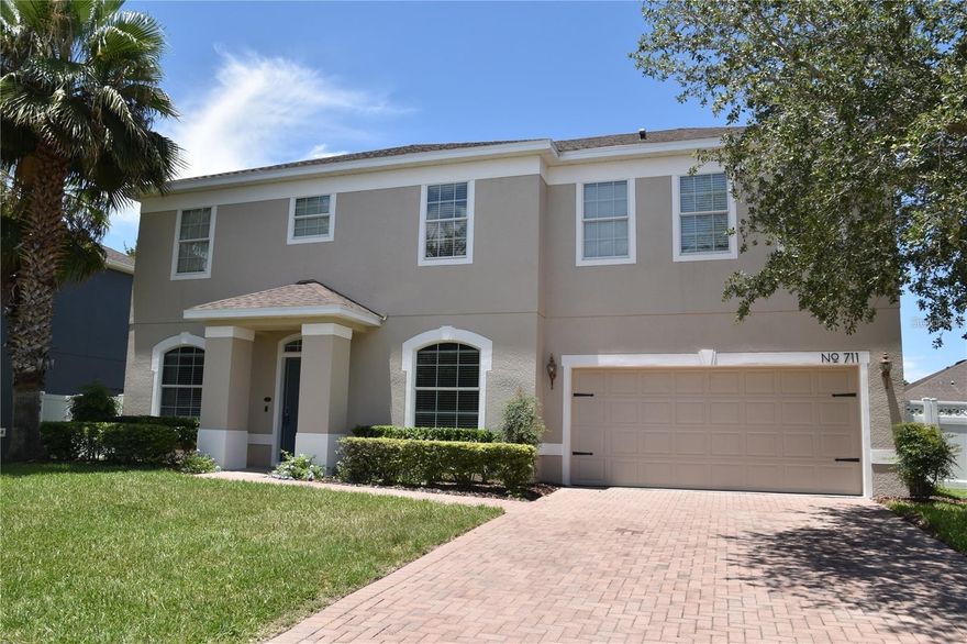 An unbelievable opportunity has become available in the quaint town of Winter Garden! Get your golf cart charged up as you call this special place home. If strolling or fitness is your hobby, this town has it all. A special place taking you back in time, while walking, running, and biking are available on the West Orange Trail that goes right through the town. This special town is sprinkled with restaurants, merchandise boutiques and plenty of bakeries and ice cream stores to cure that sweet tooth. A local brewery supports with town with special events while the mayor makes sure every holiday is celebrated, whether that is a parade, holiday music or fireworks! This leader can be seen strolling around the farmer’s market every Saturday. While the town in nestled around Lake Apopka, you have easy access to major expressways and Themed Parks. Now get ready to visit Covington Park. This newer community is nestled between the West Orange Trail and Lake Apoka. It is full of neighborhood activities and complete with a neighborhood pool playground and plenty of green space to roam. As you pull in, get ready for the magic of carefree living. As you turn past the pool, welcome to 711 Meadow Glade Drive. Only a select few can have the opportunity to live in these wonderful small-town communities. As you walk up your paver walkway, expect to be impressed with the lush landscaping. March through the door and explore the open foyer and admire your private home office to the left and formal dining room to the right. A breathtaking family room ahead with beautiful wood plank tile. This open space leads to the kitchen with a large breakfast bar and dinette for family gatherings. This gourmet kitchen includes all appliances and even the pickiest chef will enjoy. The downstairs also included a large pantry, ½ bath and ample storage underneath the stairwell. The magic continues as you exit to your backyard paradise. This screened patio and completely fenced back yard can become your private retreat to relax. When you are ready to retire for the evening, head up the stairs to your enormous bonus room and 4 private suites. The primary bedroom will accommodate the largest furniture that you can imagine! The private bath has double sinks, large shower, garden tub, commode, and a large walk-in closet. The additional 3 junior suites share the second full bath. A large laundry room upstairs is perfect for the entire family. Being footsteps from the trail with newer construction is rare, make your private appointment today while the opportunity still exists.