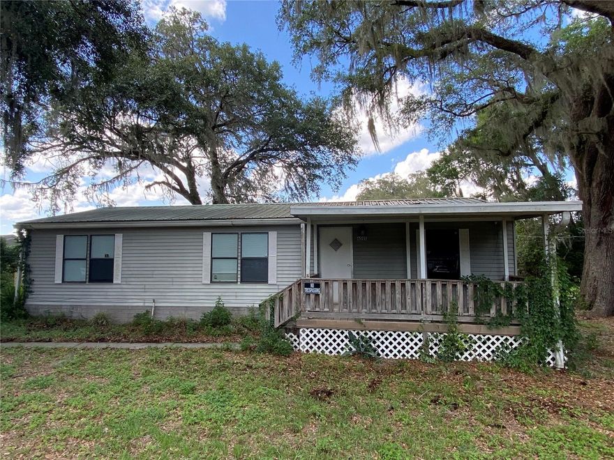 High Hopes. Quite peaceful  subdivision tucked away just off Hwy 301 in Summerfield. Great Central Florida location only 15 minutes to the villages and 20 minutes to Ocala.  And just over an hour to get to the Orlando attractions or either coast if you want to hit the oceans.  This 3 bedroom 2 bath doublewide mobile home with a metal roof (2006) was remodeled in 2022 with all new kitchen cabinets and appliances. Waterproof vinyl in kitchen dining room and Livingroom, carpet in all three bedrooms. Stainless Steel appliances. Yard features lots of shade to set back and relax, enjoy your front and back porches for extra outdoor activities. Yearly HOA dues include mowing, water and a community screened enclosed pool and club house.
Furniture is available for purchase only