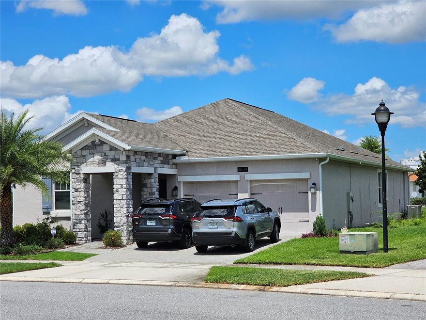Discover this beautifully maintained 4-bedroom, 3-bathroom home located in the gated community of Reflections at Storey Lake. Positioned on an oversized lot, this residence offers a thoughtfully designed 3-way split floorplan that ensures privacy and comfort throughout. At the front of the home, two spacious bedrooms and a full bath welcome you. Further down the hall, you'll find an additional guest bedroom, a second full bath, and a built-in granite desk, ideal for a home office. The open concept living, dining, and kitchen areas feature elegant porcelain tile flooring and abundant natural light, creating a warm and inviting atmosphere. The kitchen is equipped with granite countertops, glass tile backsplash, stainless steel appliances, espresso cabinetry, and a functional island with breakfast bar. The primary suite offers tray ceilings, generous natural light, and a modern en-suite bath with a soaking tub, separate shower, dual granite vanities, and a walk-in closet. Adjacent to the kitchen, the laundry room includes ample cabinet storage. Enjoy outdoor living year-round on the covered, screened-in patio overlooking a large backyard, perfect for relaxing or entertaining.