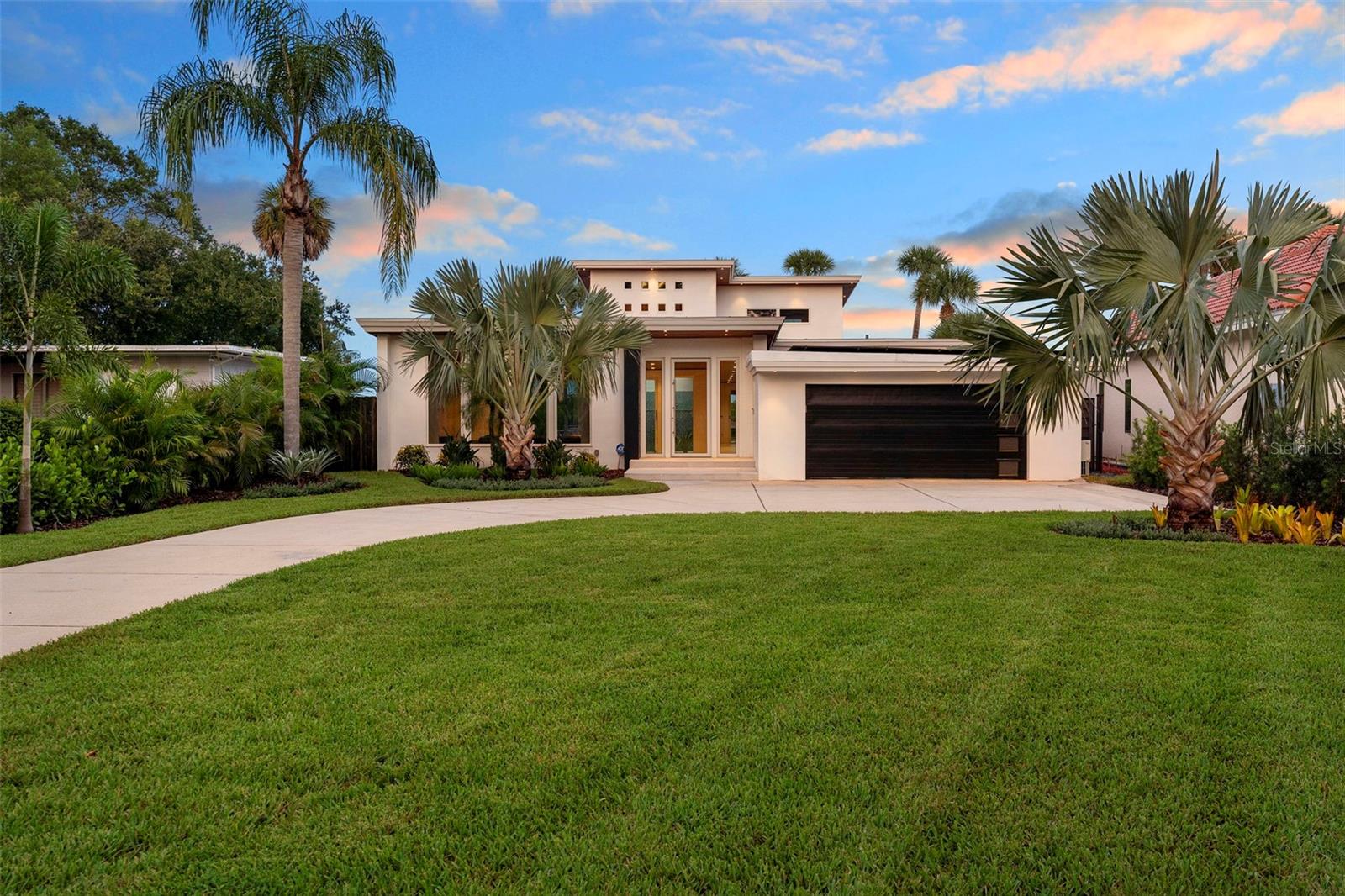 Welcome to 705 Faulkner, your new home in the heart of the Historic District of New Smyrna Beach, Florida. With awe-inspiring views, this mid-century modern, waterfront home offers a PRISTINE 84 ft. of river frontage with a private boathouse, 10,000lb lift and kayak dock. Inside, three bedrooms with three en-suite bathrooms, a dedicated office, and a chef’s kitchen with top of the line appliances from Gaggenau, Miele, & Sub-Zero define luxury living. Panoramic Euro-wall doors provide unobstructed views open to the intracoastal waters and resort-style outdoor spaces, featuring an infinity-edge heated saltwater pool/spa with a mote, outdoor kitchen with granite countertops, retractable "noseeum" screened lanai and Italian porcelain pavers. With newly installed Enphase whole-home solar, you are practically eliminating your electric bill! The upgrades in the landscaping, whole home generator, and impressive outdoor lighting features alone make this home a site to see. 705 Faulkner has all of the elegant, modern features you could want in one of NSB's most desired neighborhoods.. Just five minutes from the beach and walking distance to the flourishing Canal Street Historic Arts District, this is coastal living in New Smyrna Beach, Florida at its finest!
