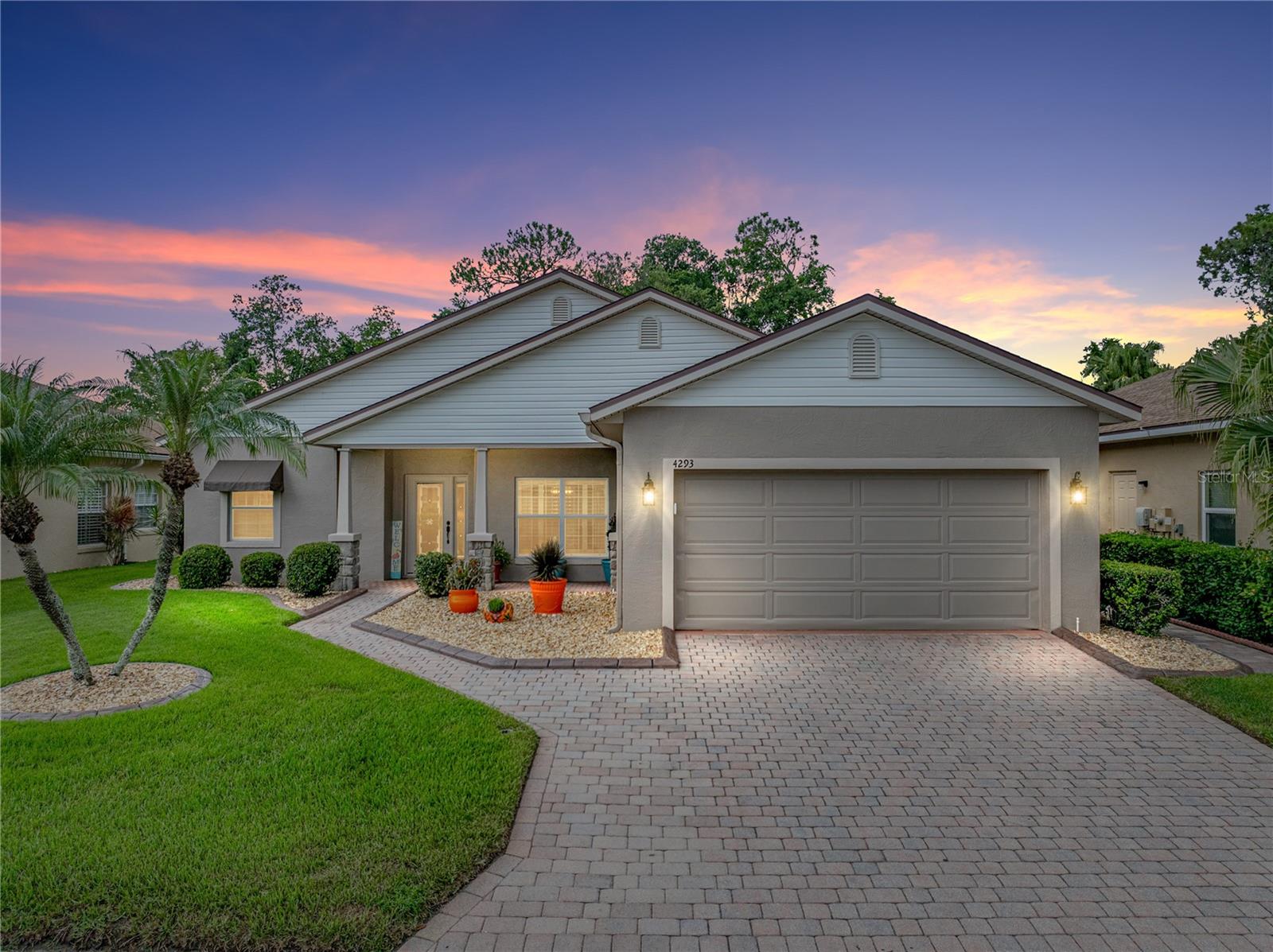 Welcome to 4293 Berwick Drive, a fully remodeled 3 bedroom, 2 bath home nestled within the highly sought after 55+ gated community of Lake Ashton in the heart of Central Florida. Designed with luxury and ease in mind, this move-in ready home showcases a neutral color palette and high end finishes throughout, setting the perfect backdrop for resort-style living. Enter through the stunning beveled glass front door into a spacious living room with an electric fireplace and adjoining dining space. The living room flows seamlessly into a large, covered lanai with private backyard views-ideal for both relaxation and entertaining. Interior features: freshly painted interior with laminate flooring, designer custom cabinetry and quartz countertops in both the kitchen and bathrooms, a gourmet kitchen with Whirlpool Stainless Steel appliances, an expanded counter top space and storage due to a re-design of the kitchen and full remodel featuring specialty drawers for cookware and trays; an eat-in kitchen area, plantation shutters with split option throughout and honeycomb blinds on the slider and in the kitchen. Outdoor living features a gorgeous 15' x 30' expanded, covered lanai with Polyaspartic flooring, outdoor seating lounge area and dining area; triple panel collapsible sliding glass doors access this outdoor space featuring views of the conservation area with no rear neighbors. An additional concrete grill slab is adjacent to the lanai. The primary suite has an updated ensuite bathroom with dual porcelain sinks, two walk-in closets plus an additional reach-in closet, a custom tower cabinet and a large, remodeled walk-in shower with premium tile, glass sliding doors and a Schluter waterproofing system. Additional highlights include comfort height toilets and vanities in both tiled bathrooms, a laundry room with extra cabinetry and tile floor with access from the garage, a paver driveway leading to a 2-car garage. The garage has a convenient outside access door as well as a laundry tub for those big projects! Recent updates: Exterior Paint (2024), Central Air (Dec. 2024), 50-gallon water heater (2025), Roof replacement (2017), Awnings (2024), Washer/Dryer (2019), LED lighting and ceiling fans throughout. Landscape curbing with river rock added in 2025. Enjoy exclusive access to a wide range of community amenities including a 26,000 sq foot main clubhouse, lighted tennis and pickleball courts, Charm City restaurant, two 18-hole golf courses (optional golf membership), indoor lap pool, outside resort style pool overlooking the lake, movie theatre, billiard room, bowling alley, fitness center, craft room, library, ballroom, three dog parks, RV and personal storage options. Don't miss this one-of-a-kind opportunity. Call today to schedule your private showing and experience the lifestyle you've been dreaming of at 4293 Berwick Dr, Lake Wales, FL.