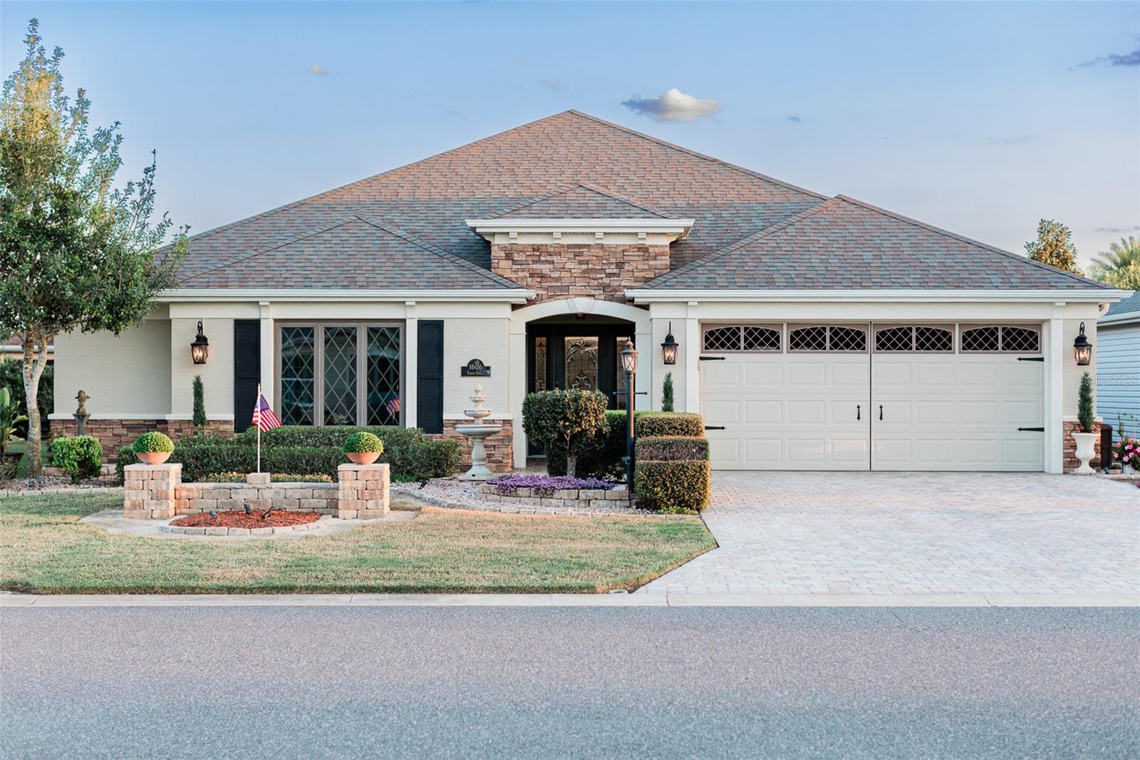 SHOW STOPPER! NOT a COOKIE CUTTER HOUSE; this house has storybook appeal! Discover this one-of-a-kind, meticulously maintained 3-bedroom, 2-bathroom home with a spacious 2-stall garage within the 10th district of The Villages. This stunning residence showcases impeccable care inside and out with countless upgrades, including two large stunning Andersen windows with diamond-shaped panes, a gorgeous foyer that leads to a large living room featuring high ceilings, custom millwork and recessed lighting. Culinary enthusiasts will love the gorgeous kitchen, remodeled in 2020, boasting top-of-the-line cabinets, solid wood doors and drawers, a custom range hood, custom quartz countertops, stainless steel appliances, an upgraded backsplash, and a premium apron sink. The thoughtful split bedroom layout offers fantastic privacy, with a separate wing for guests, complete with a pocket door separating the two guest bedrooms and bathroom from the luxurious principal suite, which boasts a private soaking tub and an upgraded bath. Enjoy the new laminate flooring in one of the three spaces bedrooms. Step outside to the backyard, affectionately named "The Serenity Garden," which certainly lives up to its name with mature landscaping, a charming paver patio, and a tranquil atmosphere perfect for relaxation and gatherings, enhanced by upgraded lighting throughout the property. 31' of retractable awnings with new fabric. Additionally, energy-efficient windows provide both beauty and functionality. Don’t miss the chance to own this exceptional home in a vibrant community with easy access to golf courses, recreational activities, shopping, and dining options. Schedule your private showing today! Please note that the chandeliers in both the foyer & the dining room, along with the ceiling fans in the living & primary bedroom will be replaced.