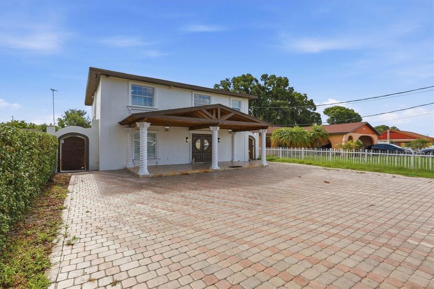 This beautiful pool home is located in the heart of Tampa Bay. It combines elegance and practicality, offering a total of 5 bedrooms and 3.5 bathrooms. The inviting front porch is perfect for relaxing, and the home has been recently remodeled with modern features throughout. You'll find tile flooring, high-end granite countertops with waterfall edges, solid wood cabinets, and a striking accent wall in the living room. The pool area features newer equipment and a heating system, and the extended porch includes a full-size outdoor kitchen. The backyard is maintenance-free, finished with travertine-style tiles and a custom block fence for added luxury. Upstairs, modern touches include a high-end metal railing on the stairs and a convenient laundry area. The master suite offers a large walk-in closet and a spacious bathroom with a walk-in shower. Two more bedrooms and a fully remodeled bathroom complete the second floor. A special bonus is the separate two-bedroom, one-bathroom mother-in-law apartment, which can provide extra income or extra space for multigenerational living. This apartment has its own private entrance, and there is plenty of parking on the large driveway. Located in a prime spot between Midtown and Carrollwood, you'll be close to a variety of restaurants, the International Mall, and Tampa International Airport. This home offers unbeatable convenience and location.