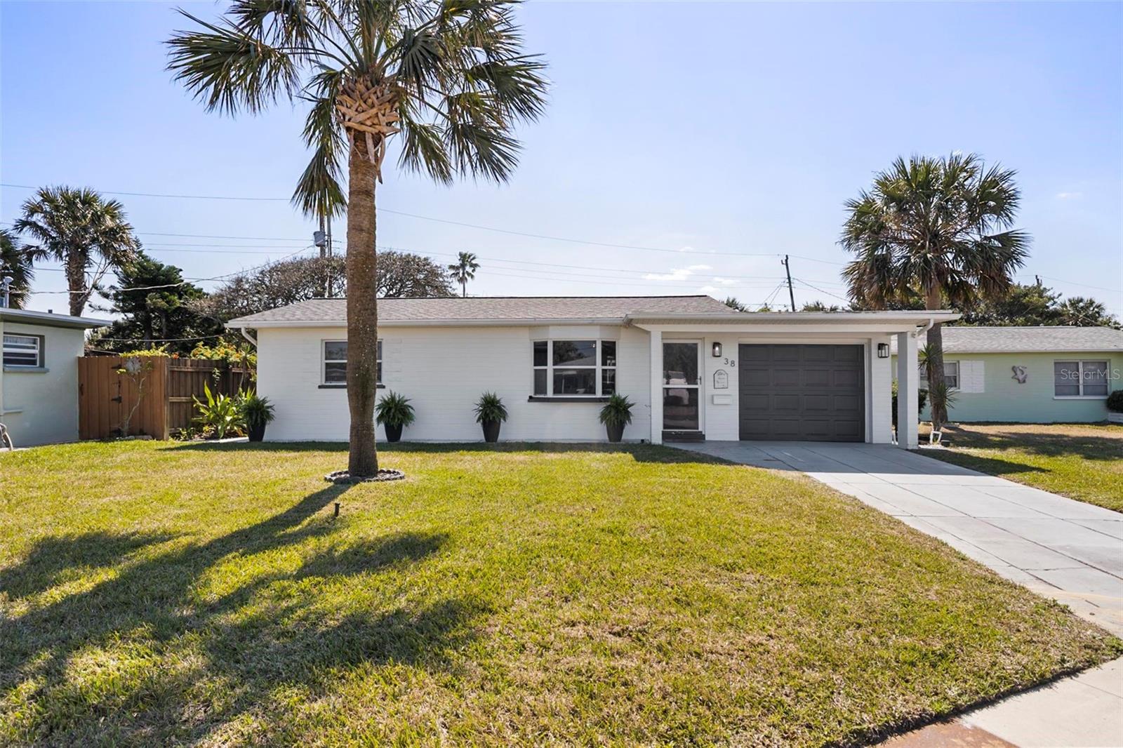 Welcome to your dream home! This charming 2-bedroom, 1.5-bathroom coastal retreat perfectly blends modern updates with timeless beachside living. In 2024, significant renovations were made, including a brand-new water heater, roof, well, sprinkler system for both the front and back and a lush lawn. The year prior, the home was further enhanced with an office conversion, sleek stainless steel appliances, and a comprehensive electrical revamp. Inside, you'll find two spacious, light-filled bedrooms, a full bathroom, and a half bathroom. A versatile flex room offers endless possibilities, whether you need a guest space, gym, or playroom. The sunroom, bathed in natural light, provides an inviting haven to relax and enjoy the outdoors from the comfort of your home. Outside, the fenced-in backyard offers privacy, while the lovely lanai and convenient outdoor shower add to the charm.