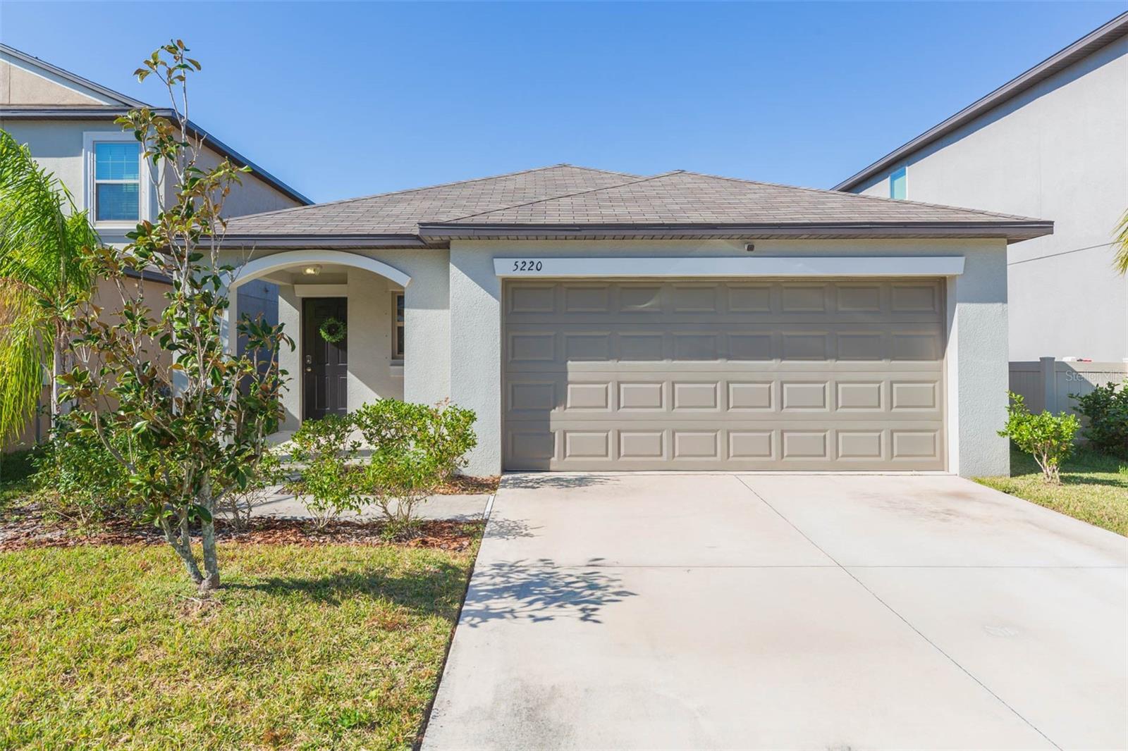 Why wait to build? Completed in 2021, this single-family home in Lynwood sits on a POND LOT and features 3 bedrooms, 2 baths, and 1,451 sqft of living space! The bright and airy kitchen boasts recessed lighting, granite countertops with a large center island, stainless steel appliances (including a gas range!), and an open-concept layout overlooking the combined dining and living room, ideal for hosting and entertaining. Glass sliders lead out onto the covered concrete slab where you will enjoy the peaceful water views and a fully fenced backyard. The primary bedroom offers total relaxation with water views and an ensuite bathroom complete with granite countertop dual vanity sinks, a tiled shower, and a spacious walk-in closet. The secondary bedrooms are tucked away from the primary for added privacy and share the remaining nearby full bath. The Lynwood community has a resort-style pool, playground, and green spaces for outdoor activities. You are just minutes from shopping, dining, the Manatee Viewing Center, and E.G. Simmons Conservation Park where you can go camping, kayaking, play volleyball, fish, and observe wildlife and bird watching within the 200-acre sanctuary. Commuting into downtown Tampa, Tampa International Airport, and MacDill Airforce Base is a breeze with easy access to I-75.