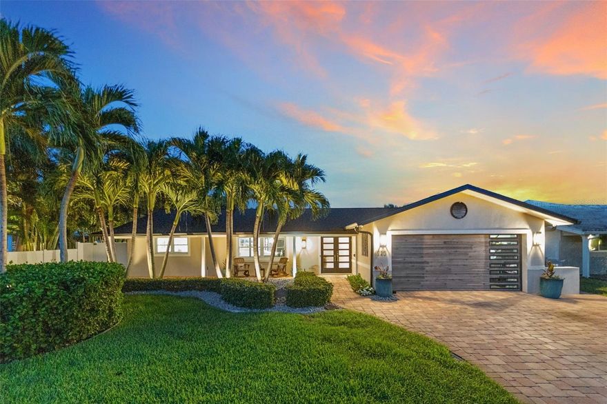 Welcome in! One of the most important things to know about this home in the highly-desirable Yacht Club Estates neighborhood is that this elevated lot DID NOT TAKE ON ANY WATER during last year’s hurricane; a tremendous peace of mind for waterfront living. As you approach the home, you’ll notice the updated exterior with new hurricane-rated front door and garage door, as well as, a brand-new roof, gutters & facia. Inside, the first thing you’ll notice is the fully-remodeled gorgeous gourmet kitchen equipped with modern Thermador and Bosch appliances. The kitchen also features premium finishes with solid wood cabinetry, quartz countertops, and a layout that flows seamlessly into the main living area. This home offers over 2,200 square feet of space with 3 bedrooms and 2 bathrooms, plus the convenience of a 2-car garage with washer/dryer hook-up access. In this home you’ll find an oversized, walk-in pantry with an additional W/D hook-up for indoor convenience. The second bedroom includes two built-in Murphy beds, making it perfect for visitors or flexible living. The primary suite is a true gem. Not only does it capture peaceful water views, but it also features an absolutely amazing California Closet custom-designed dressing room boasting exceptional storage, a vanity/makeup station and organization that is sure to impress. Step out back to the travertine-paved patio with a custom, built-in outdoor kitchen and a backyard overlooking Boca Ciega Bay, perfect for gatherings or quiet evenings. For boaters, the property is perfectly located in a protected area that includes a private dock with a 13,000 lb boat lift, making water access effortless. Overall, it’s a rare combination with peace of mind, high-end finishes, and true luxury waterfront living. Listed $25,000 under appraised value (9/25), come and see your new home.