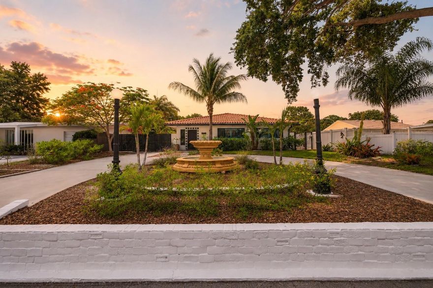 Situated 20 feet above sea level and located in a NON-FLOOD ZONE, this exceptional Pasadena Estates residence offers a rare blend of character, flexibility, and modern upgrades just steps from Stetson University College of Law and minutes from the beaches, downtown Gulfport, and vibrant downtown St. Petersburg.

This property welcomes you with lush landscaping, a striking centurion fountain, expansive paver-lined entryways, and impressive curb appeal enhanced by a brand-new driveway gate. Step through the new custom steel front door into a light-filled interior featuring an abundance of brand-new PGT impact windows and doors, new imported Saltillo tile flooring, and timeless character throughout.

The spacious floorplan offers 4 bedrooms and 4 baths, including a flexible private guest or in-law suite complete with its own entrance, kitchenette, full bath, and secluded garden area — ideal for multigenerational living, hosting guests, a private workspace, or income-producing potential. An additional bonus room offers flexibility for a home office or flex space, while the mini garage provides valuable extra storage space.

Designed for both entertaining and everyday living, the chef-inspired kitchen features an oversized gathering island, gleaming granite countertops, marble backsplash, and brand-new stainless-steel appliances. The spacious living room flows effortlessly into a separate dining area, creating an inviting setting for gatherings of any size.

Additional recent improvements include a whole-house solar system, whole-house water softener, new irrigation system, remote window treatments, vapor fireplace, remodeled main bathroom, fresh interior and exterior paint, and new rain gutters.

Outdoor living is equally inviting with an expansive tiled patio surrounded by mature greenery, offering the perfect backdrop for alfresco dining, quiet mornings, or relaxing beneath the trees. The oversized lot provides secured parking for up to eight vehicles with additional room for a boat, RV, or future lap pool and spa.

Conveniently located near Pasadena Plaza, St. Pete Beach, Treasure Island, waterfront dining, shopping, and famous Florida beaches, with Tampa International Airport approximately 30 minutes away, this is a truly rare opportunity to own a distinctive property in one of the area’s most desirable neighborhoods. Schedule your private showing today.