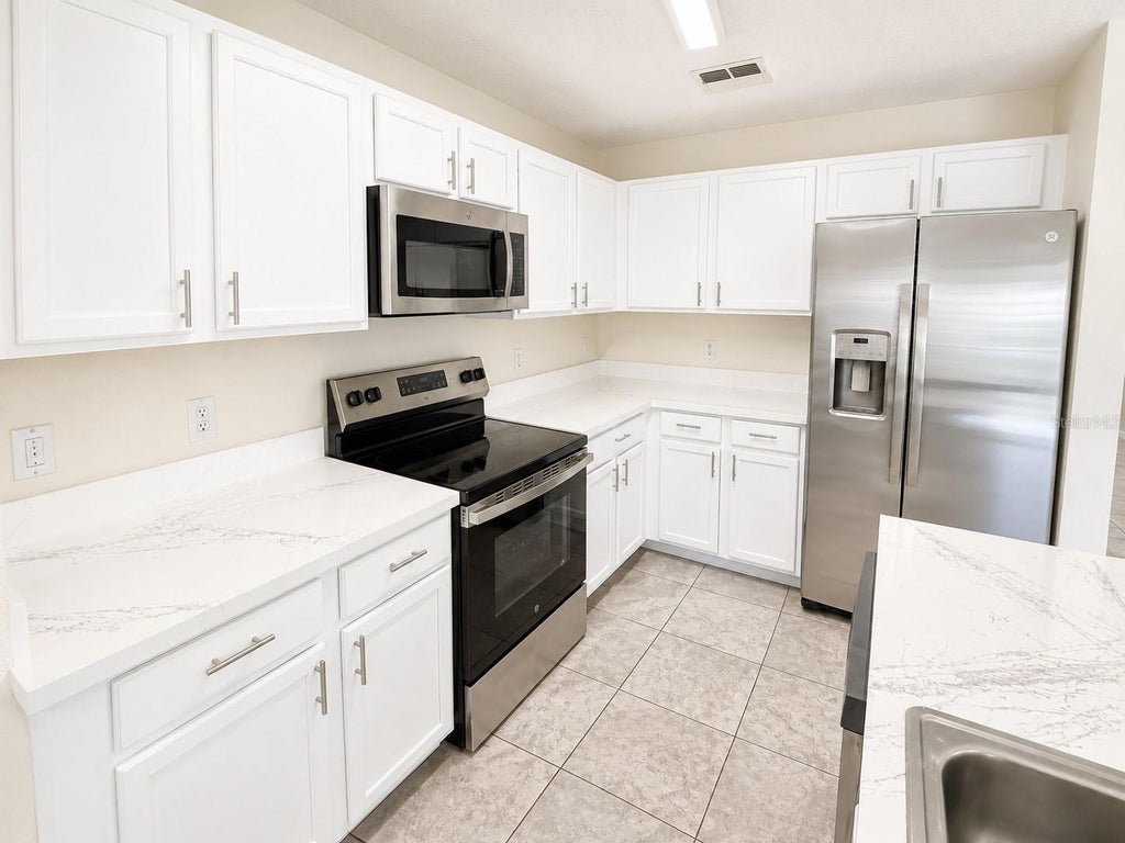 Photo of 13507 Tea Rose Way #128, Orlando, FL 32824 (MLS # O6437250)