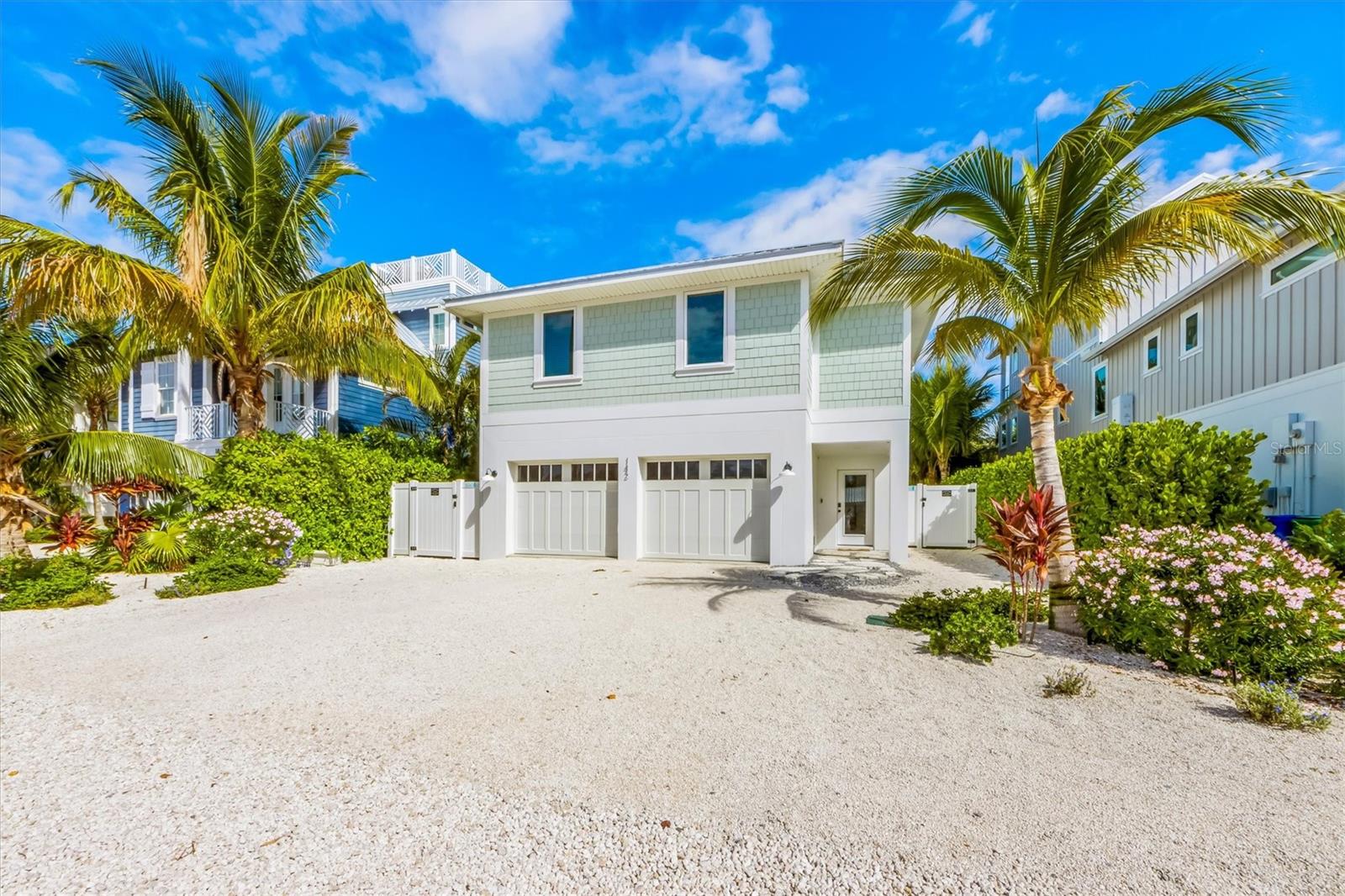 Discover your piece of paradise! This newer construction charming beach home is located on Crescent Drive in Anna Maria, Florida. It offers the perfect blend of coastal living and modern comforts. With its prime location, stunning views, and exceptional amenities, this property is the perfect home or investment. Nestled on the northern end of Anna Maria Island, this home offers easy access to pristine sandy beaches and the best shopping street - Pine Street. Also with this home you get direct access to the crystal-clear waters of both Tampa Bay and the Gulf of Mexico - with a dock in your backyard. Bring your boat, kayaks or paddle boards. This thoughtfully upgraded turnkey furnished house has an open-concept living area and showcases oak hardwood flooring and eight-foot doors. The home features four bedrooms, each thoughtfully designed for comfort and relaxation with beautiful ensuite bathrooms. Take either the elevator or the stairs up to the elegant master bedroom located on the third floor which has a walk-in closet, his and her vanities, a walk-in shower, and an en-suite balcony. The gourmet kitchen offers well-known high-end appliances such as a Subzero refrigerator, a Wolf Range with hood, a Bosch dishwasher, and a Sharp drawer microwave. The kitchen's center island has polished butcher block wood and acts as a family gathering place under the soft lighting. Enjoy your meals at the dining room table off the kitchen with picture frame windows and southern exposure. Split your time between the lanai and the inviting living room separated by floor-to-ceiling sliding glass doors. The living space boasts high ceilings, creating a warm atmosphere perfect for gathering with family and friends. Step outside to a private paradise with a heated saltwater pool and spa with a sun shelf. Bask in the salty island breeze in the privacy among the lush tropical landscaping in your luxurious oasis. Unwind in the outdoor living room with a new seaglass tile accent wall and outdoor TV built to last in the elements. How can you make an already perfect home better? Well, the current owner's did it through many additional upgrades completed in the last year include interior paint throughout the entire home, all new faucets, shiplap installed in the living room kitchen and all four bedrooms, new furniture throughout, 55” outdoor TV Installed with sound bar, exterior furniture, palm trees and several hedges for privacy, beautiful stone added to the driveway and around perimeter hedges, hardware for kitchen and bathroom cabinets, two two-person kayaks with rack and kayak cart, lighting fixtures for both interior and exterior, changed out all of the door hardware to a black finish, travertine pool deck, pool refrigerator located in the bonus room, air conditioning system added for the bonus room on the first floor, and Tesla super-charger located in the two car garage. Additional amenities include a private elevator and a putting green. Anna Maria Island is known for its charming shops, excellent dining, and relaxed beach lifestyle. All are within a few minutes walking distance. Explore the island's vibrant arts scene, water sports, and natural beauty. Whether you're seeking a year-round residence, a vacation home, or an investment property, this is a rare find.