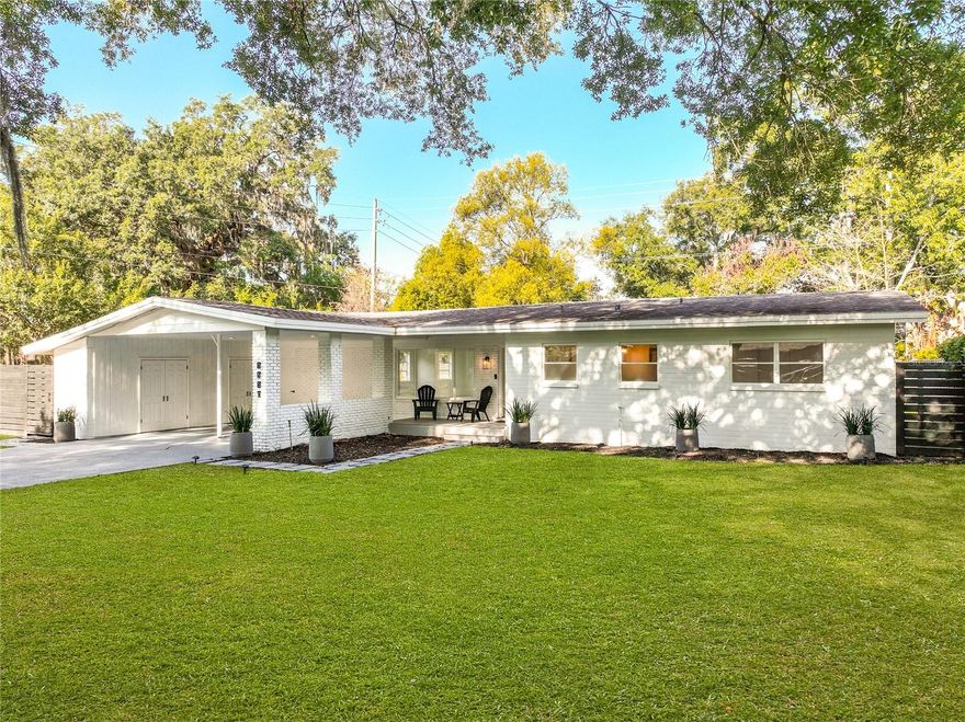 BEL AIR BEAUTY! Situated on a quiet, tree-lined street, this mid-century modern home blends modern updates with timeless charm. Offering three well-proportioned bedrooms and two full bathrooms, it provides an ideal layout for comfortable living, making it the perfect spot for your growing family. A covered parking area and inviting front porch create a warm welcome. Inside, the spacious living area is filled with natural light from large windows and sliding doors, offering an open and airy setting for both everyday living and entertaining loved ones. You will be immediately drawn to the renovated kitchen featuring modern white cabinetry, quartz countertops, a designer range hood, and stylish backsplash. Both the guest bathroom and primary en suite have been thoughtfully refreshed with new flooring, fixtures, and finishes. Set on nearly a 1/4 lot, the property offers expansive front, side, and backyard space—a blank canvas for creating your own private outdoor retreat. The covered rear patio also provides a relaxing place to unwind in the evenings. Additional highlights include an enclosed laundry room with extra storage, new recessed lighting, updated electrical and plumbing systems, newer roof (7 years), newer HVAC system (3 years), new exterior doors, updated interior hardware, and fresh interior and exterior paint. If location is your motivator, this home offers one of the best in Orlando! Loated in the highly sought-after Bel Air Hills neighborhood, you'll are just a few blocks from the Hourglass District and just minutes from Thornton Park, the Milk District, and the SoDo District, as well as Downtown Orlando’s dining, entertainment, athletic and cultural venues. Convenient access to State Road 408 and I4 adds to the appeal. Added bonus...the A rated schools include Lake Como K-8 and Boone High School. Please reach out to book your showing today, we don't expect this gem to last long!