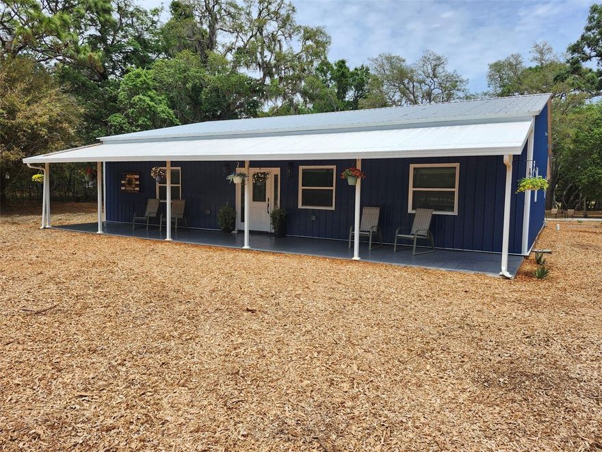 Custom-Built 3 Bedroom, 2 Bath home on 2.75 Acres with Pool, Workshop, and No HOA

Welcome to this stunning 2024 custom-built home, perfectly situated on 2.75 acres of AG-zoned land with no HOA and not located in a flood zone. Designed with both comfort and functionality in mind, this property offers the ideal blend of modern living and country lifestyle — with room for horses, cows, goats, and more.

Step inside to an inviting great room featuring a built-in electric fireplace and integrated TV, creating a warm and modern focal point. The open-concept layout flows seamlessly into the eat-in kitchen and dining area, where every detail has been thoughtfully selected.

The beautifully designed kitchen showcases striking blue cabinetry, quartz countertops, stainless steel appliances, and a classic subway tile backsplash. Large windows and French doors bring in natural light and lead to a back porch, offering peaceful views of the pool and expansive yard.

Outdoor living is also where this property truly shines. Enjoy evenings around the fire pit, relax by the above-ground pool with surrounding deck, or take in the wide-open space that makes this property perfect for entertaining or unwinding. With well and septic already in place, there is also the opportunity for a more self-sufficient, off-grid lifestyle.

The land is already set up for animals with livestock and chicken pens, making it ideal for those looking to embrace a homestead lifestyle.

To the left of the main living area, the spacious primary suite offers a private retreat. The walk-in closet features custom shelving and drawers and the closet and en-suite bathroom are both accessed through stylish barn doors. The primary bathroom is beautifully appointed with a glass-enclosed shower featuring a rain head, handheld, and body jets, along with a soaking tub, all surrounded by elegant octagon tile on the floors and walls. A double vanity with granite countertops completes the space.

The opposite wing of the home includes two additional bedrooms and a full bathroom, providing flexibility for family or guests. 

A large indoor laundry room offers abundant cabinetry and storage, with barn doors that discreetly conceal the hot water heater and utility area.

A major highlight is the 30x50 x 14 shop (built in 2024) with space for 4-6 vehicles, equipment, or hobbies, making it perfect for work or recreation.

For those looking to expand, the adjacent 5-acre parcel is also available for purchase, offering even more opportunity to create your ideal property.

This one-of-a-kind property offers space, privacy, modern finishes, and true lifestyle flexibility — all in a beautifully designed home.

Schedule your private showing today!