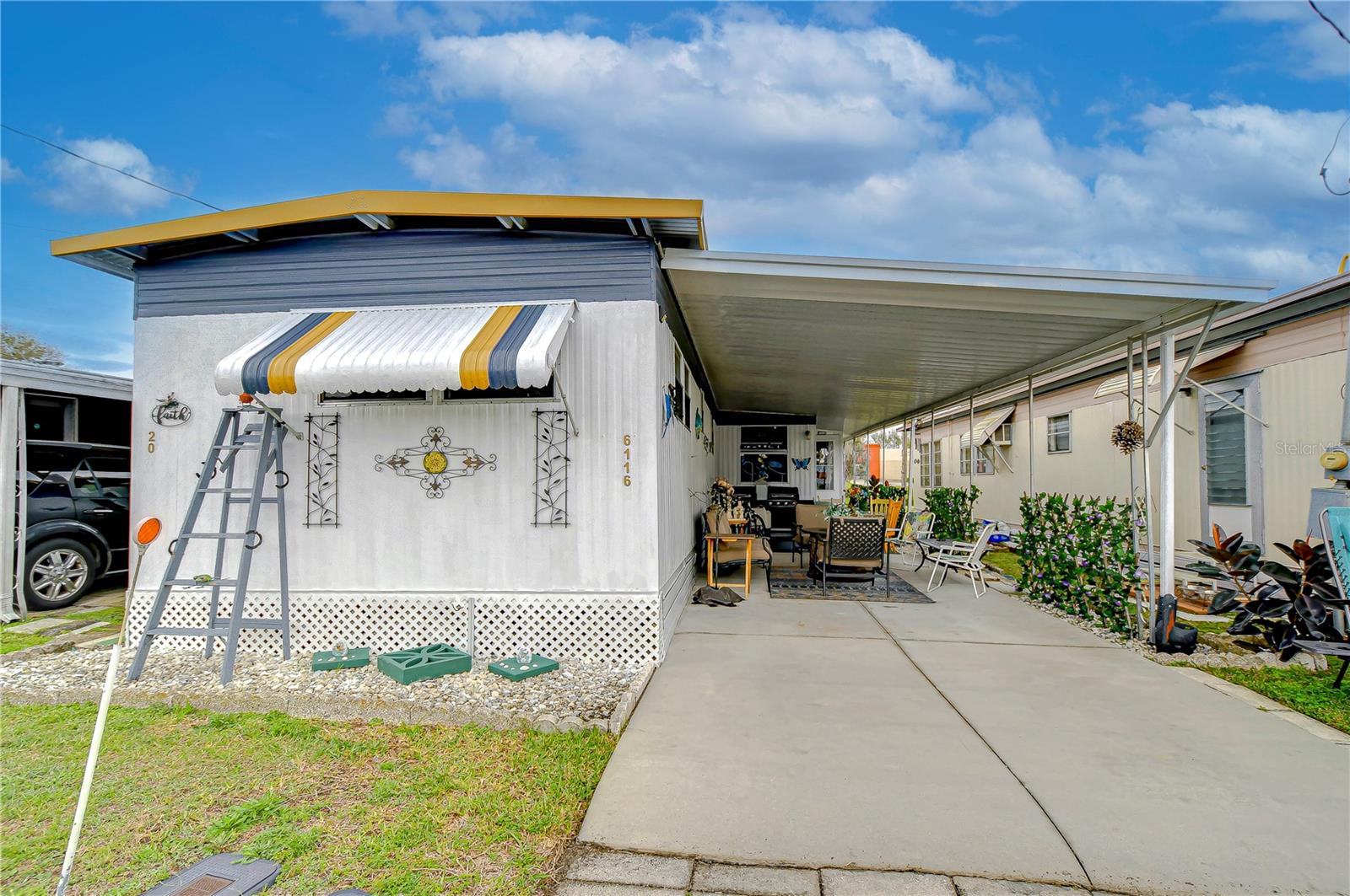 Charming & Affordable Senior Living in Zephyrhills. Step into this beautifully updated singlewide mobile home, located in the peaceful 55+ community of Pinecrest Mobile Home Park. From the moment you arrive, you'll appreciate the welcoming feel of this home, complete with a carport for convenient parking. As you enter through the Florida room, you'll immediately notice the difference—this space has been upgraded with glass windows instead of plastic screens, making it a bright and comfortable area to relax year-round. Inside, the home has been completely redone, offering a modern yet cozy feel. The spacious layout makes it hard to believe it’s a singlewide, with an open floor plan that flows seamlessly from room to room. The kitchen was updated just three years ago with beautiful custom-built cabinets, providing ample storage and a stylish touch. The walls are painted in a soft, neutral color, allowing natural light to fill the space, creating a warm and inviting atmosphere. The flooring in the bedrooms, kitchen, and bath has all been updated, adding to the home’s fresh and move-in-ready appeal. This home comes furnished, making it even easier to settle in and start enjoying everything this quiet, well-maintained community has. Pinecrest Mobile Home Park is a small senior community with low monthly fees that include water, sewer, trash, and lawn maintenance. Conveniently located near Zephyrhills' favorite local diners, it's just a mile from the YMCA and a short drive to outlet malls, beaches, and Orlando’s famous theme parks. Why pay high lot rent when you can own your land and enjoy affordable living right here in town? This home is a rare find—don’t miss your chance to see it for yourself!
