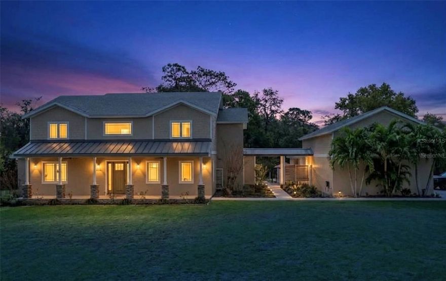 One or more photo(s) has been virtually staged. Private 4.13 acre GATED ESTATE in beautiful Beauclair Ranch Club-an EQUESTRIAN community offering space,privacy,and exceptional functionality. This CUSTOM BUILT property truly has it all! The estate features a 3,444 SF MAIN residence with 4 bedrooms, 3.5 baths, and a DEDICATED OFFICE. Also included is a fully equipped, detached ADDITIONAL RESIDENCE (ADU) with FULL KITCHEN, LIVING ROOM, BEDROOM, and BATH-ideal for MULTIGENERATIONAL LIVING, a work from home private retreat, or INCOME POTENTIAL. Designed for both everyday living and entertaining, the main home offers an open concept layout centered around a chef's kitchen and a stunning wood burning fireplace. The well appointed kitchen is equipped with THERMADOR APPLIANCES, a six burner propane gas range, QUARTZ countertops, a large island, and abundance of CUSTOM CABINETRY. A built in WET BAR with WINE STORAGE and beverage refrigerator enhances the entertaining space. Extensive property upgrades provide efficiency, security, and long term resilience, including a NEW ROOF (2025), OWNED SOLAR system with 5 BATTERY BACKUPS, Three TESLA charging stations, TWO WELLS ( one backup), 1000 GALLON buried PROPANE TANK, 3 TANKLESS HOT WATER HEATERS, and a WHOLE HOUSE WATER FILTRATION and SOFTENING SYSTEM. Security and preparedness features include a FEMA RATED SAFE ROOM, 3M SECURITY WINDOW FILM, RING doorbell and a LOREX SECURITY SYSTEM WITH CAMERAS. The property is built for lifestyle and storage, featuring a THREE CAR detached garage with a BENDPAK CAR LIFT, a full length garage attic with built in shelving, and ample space for cars, boats, RV's and recreational toys. Outdoor amenities include a WELLIS SPA, large CUSTOM FIRE PIT, MATURE FRUIT TREES, a FENCED GARDEN AREA, and expansive open land with plenty of room to add your dream pool. Located just minutes from the HARRIS CHAIN OF LAKES PUBLIC BOAT RAMP, this property offers convenient access to Central Florida's premier boating and fishing waters. A rare combination of craftsmanship, acreage, upgrades and versatility in a gated equestrian setting, this property is a one of a kind don't miss opportunity!