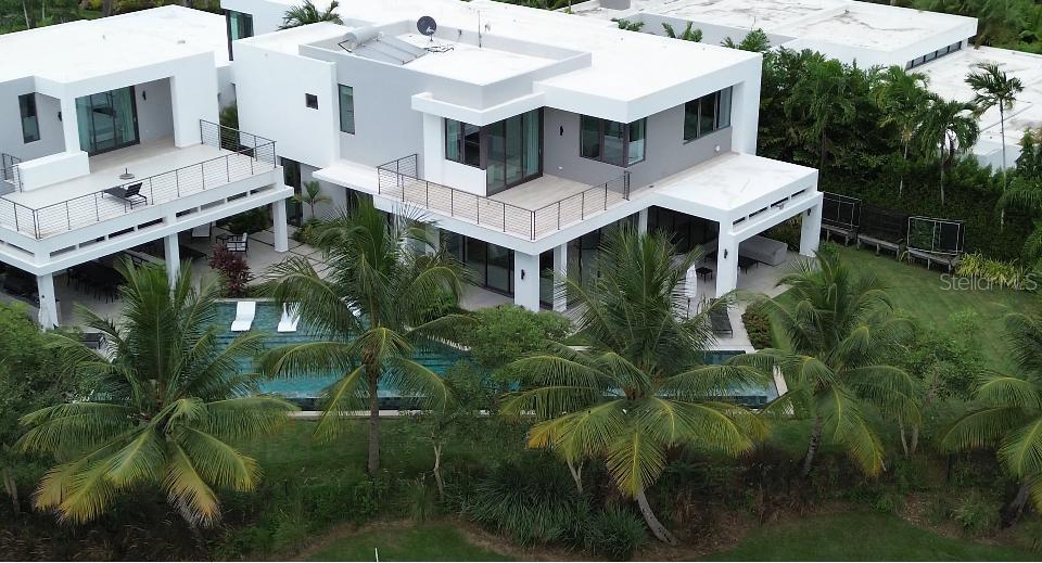 Introducing this stunning estate that offers approximately 7,000 sf of unparalleled luxury living space and functionality. The main house features 4 bedrooms, 5 full baths, 2 family rooms, and a spacious living room. A large walk-in pantry, dual laundry rooms, and a mudroom ensure convenience at every turn. Thermador appliances grace the kitchen, complemented by custom closets throughout. Additional highlights include a freezer in the garage and two refrigerators with freezers. The guesthouse provides a private retreat with 1 primary suite, 2 full baths, and a kitchenette. Step outdoors to discover an oasis complete with an outdoor kitchen featuring a pizza oven, BBQ, sink, and fridge. Enjoy the saltwater pool heated to perfection or explore the expansive grounds with ease using the 4-car garage and 4 golf carts. This exceptional property offers the ultimate in luxury living, blending comfort and sophistication effortlessly.