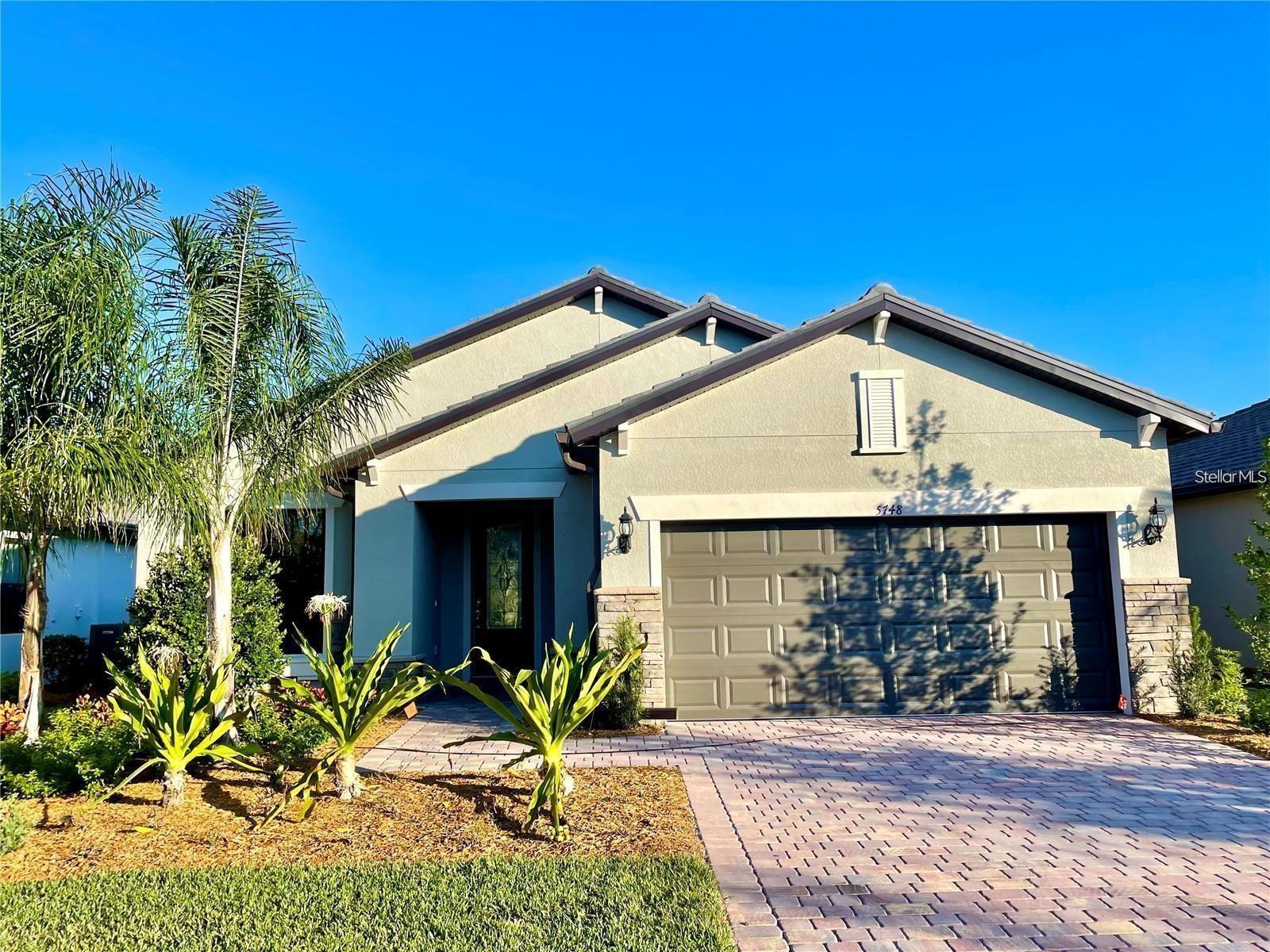 Location, Location, Location! Want an almost new home in Always Popular Hammock Preserve? Here's your chance to be one of the first to occupy this beautiful Palmer Ranch area 3 bedroom, 2 bath plus den home with a 2-car garage in the amenity-rich community of Hammock Preserve. Indoor maintenance is a breeze also with a bright open floor plan and tile throughout. The foyer opens up to the kitchen with a walk-in pantry, and a beautiful large island with seating adjacent to the dining area. The spacious gathering room has coffered ceilings with sliding doors out to the covered lanai overlooking the private back yard. The owner's suite has a large walk-in closet and bathroom with a shower and dual sinks. The den/flex space has French doors. Built by DiVosta, this is an active, maintenance free, luxury lifestyle community with well-rated schools. Each home is lushly landscaped with automatic sprinkler system. The Clubhouse in this active community contains a social room where residents can meet to play cards, games, book discussions and hobby groups, fitness center and bar area or relax and enjoy the community fire pit on cooler evenings with neighbors. Hammock Preserve also features a resort-style pool and spa. Enjoy time with family and friends by scheduling a game of tennis, pickle ball or bocce ball. Take a nice long walk through the community or enjoy evenings by the community fire pit. Hammock Preserve is close to shopping, grocery stores, Costco, banking, medical offices and hospitals. The Legacy Trail is minutes away and used for biking and hiking from Sarasota to Venice. World famous Siesta Key Beach is just about 10 miles away and there are many golf courses to choose from in the area. Hammock Preserve, just off Honore Avenue, is close to I-75 and US 41 for easy access and commutes.