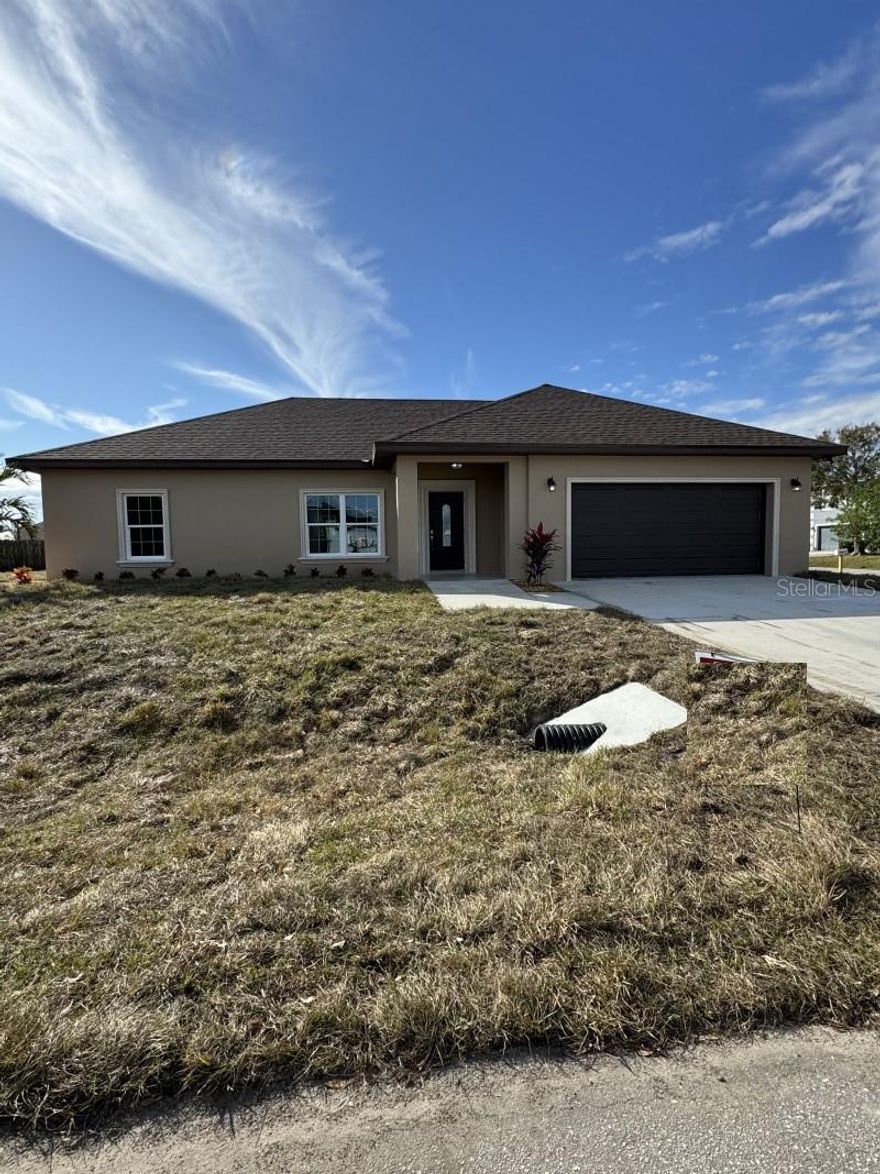 Under Construction. Brand New custom home!!! This home is near completion and available Mid-February 2026. Pictures will be updated at completion. Conveniently located close to all the amenities Okeechobee has to offer, plus a short travel to the coast, as well as Everglades elementary within walking distance! This home is not your typical home. This home features 1690 square feet under air, 2,255 square feet total, it is a 3-bedroom 2-bathroom home, what makes this home so special? This home features custom finishes not found in your typical home, your typical home has wood baseboards and door moldings, here you will find beautiful CONCRETE 7 1/4" baseboards and 4" decorative CONCRETE door moldings. you won't ever have to worry about water damage to these, you will NOT find this in any other home! it doesn't end there, step outside you will find the same beautiful concrete moldings and windowsills surrounding every window and door, a must see to appreciate! Other features include spray foam insulation for maximum energy efficiency, Granite countertops, a kitchen island, a formal dining room, Porcelain wood look tile floors in the bathrooms, living room, and kitchen, with the 3 bedrooms having upgraded carpet. The master bathroom features an oversized walk-in shower AND separate soaking tub beautifully decorated with Tile and concrete moldings, along with a 2-sink vanity. All closets feature beautiful all custom wood shelving, plenty of room for clothes!!  For your heating and cooling you have a Heat pump system made by Trane. The home features custom impact resistant windows and Doors made by well know window manufacturer PGT. You have beautiful French doors with all exterior porches covered in beautiful durable tile. This home also features an oversized 2 car garage, bring your oversized big truck inside!! Outside you will find the beautiful landscaping with beautiful brown river rock to complement the landscaping, a must see to appreciate!!!