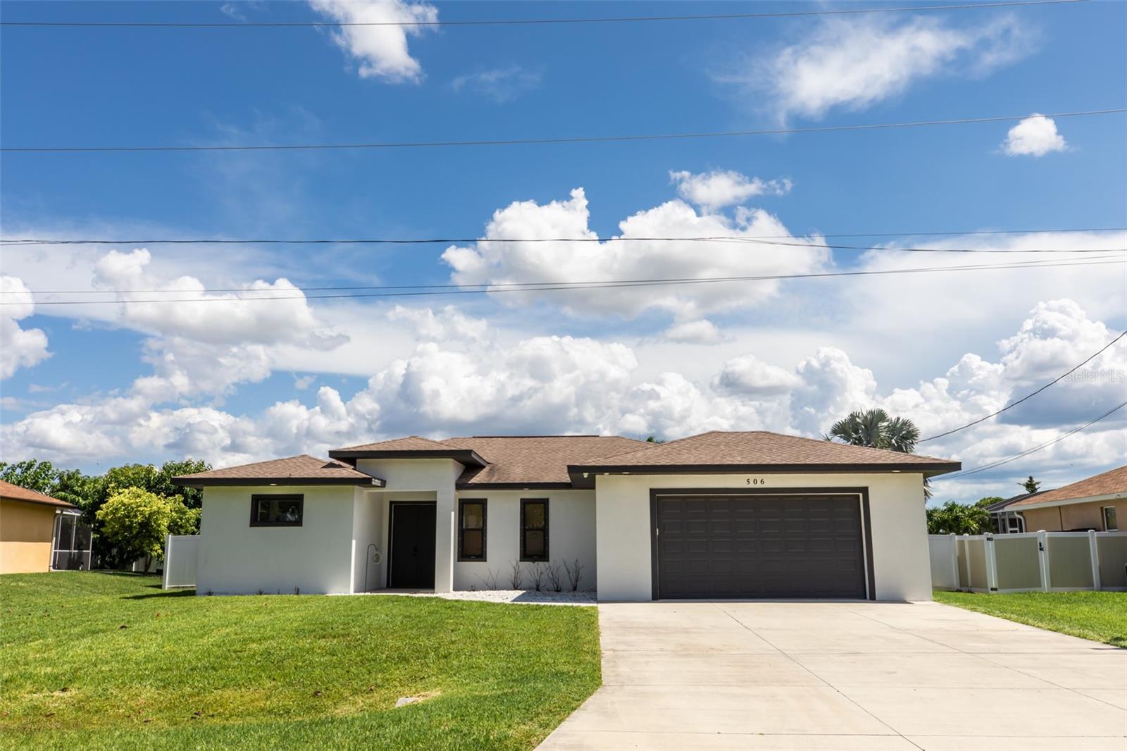 BEAUTIFUL 3 Bedroom, 2 Bathroom, 2 Car Garage, Pool home with a Den/flex room situated on an oversized lot in Cape Coral. NO HOA FEES & NO FLOOD REQUIRED! CLICK ON THE VIRTUAL TOUR LINK 1 FOR THE VIDEO AND VIRTUAL LINK 2 FOR THE 3D TOUR. This lovely home features a bright & open floor plan, luxury vinyl flooring throughout, tray ceilings, recessed & pendant lighting, and MUCH MORE! The open-concept living space makes this home ideal for entertaining friends and family, with a large glass slider to the lanai that seamlessly blends indoor and outdoor living, allowing guests to flow easily between the cozy interior and the breezy, sunlit patio. The kitchen offers ALL stainless-steel appliances, Quartz countertops, a walk-in pantry, and an island with a breakfast bar. A spacious master suite has DUAL walk-in closets and a private bathroom with split vanities, a linen closet, a claw foot soaking tub, and an all-tile walk-in shower with two shower benches. The a second master suite and guest bedroom are on a split floor plan providing plenty of privacy. The second master suite has dual built-in closets and a private bathroom with a single sink vanity and walk-in shower. The third bedroom has a built-in closet and a guest bathroom nearby with lanai access. The den is a versatile space with endless possibilities - perfect for a home office, media room, home gym, or an additional guest bedroom, this space is designed for flexibility that can easily adapt to your needs. Sip your morning coffee or unwind with your favorite evening beverage on the spacious lanai, with ample room for entertaining. Relax in style with a private pool and spa featuring a Baja shelf, or soak up the sun on the spacious pool deck. Enjoy the privacy of a FULLY FENCED backyard, perfect for letting pets roam freely, creating a safe play area for children, or hosting weekend barbecues with friends and family. With room for a garden, fire pit, or outdoor seating, it’s a space that easily adapts to your lifestyle. 2019 ROOF - 2019 POOL - 2022 UPGRADED POOL W ADDED SPA - 2022 LANAI - HURRICANE PROTECTION - FURNITURE NEGOTIABLE. Conveniently located with easy access to parks, schools, shopping, and dining. Enjoy nearby recreational spots like Sun Splash Water Park, Cape Coral Sports Complex, Strausser BMX Sports Complex, and Four Mile Cove Ecological Preserve, plus easy access to boating and outdoor activities along the Caloosahatchee River, with a short drive to local award-winning beaches. Schedule your showing TODAY!