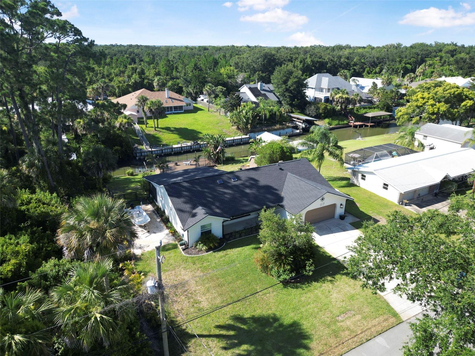 Welcome to 117 Azalea Drive—your private waterfront escape in the peaceful Waterway Park neighborhood of Edgewater. This beautifully updated home sits on a saltwater canal with direct access to the Halifax River and out to the ocean. Enjoy the Florida boating lifestyle with your own private two-story dock and boat lift, perfect for fishing, sunset cruises, or heading straight out to sea.
The home has been thoughtfully upgraded with a brand-new roof, fresh exterior stucco, and new composite decking on the dock. Inside, you'll love the open floor plan, updated kitchen with granite countertops and stainless appliances, and a spacious new walk-in closet in the master suite. Tile flooring runs throughout, and the bathrooms have been tastefully updated to match the home's coastal charm.
Located on a quiet, low-traffic street with friendly neighbors and no HOA, this property offers true peace and privacy. Whether you're enjoying your morning coffee by the water or watching the breathtaking sunsets from your dock, life here feels like a permanent vacation. Don't miss your chance to own a piece of Florida paradise with deep water access, modern updates, and a backyard built for the best days of your life.