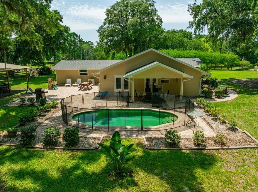 This home is in the heart of Micanopy, FL—this incredible 10-acre estate offers the perfect blend of space, privacy, and flexibility. The main home features 3 spacious bedrooms and 3 full bathrooms, complete with a sparkling pool that’s perfect for Florida living. Recently remodeled with a newer roof on both homes! But that’s not all—this property also includes a massive detached modular home with 3 additional bedrooms and 2 full baths, ideal for guests, extended family, or even investment opportunity. Zoned AG, it's ready for horses, gardening, or your next big idea. Yes, it’s country living—but you’re not far from convenience. Just 15 minutes to Publix, 30 minutes to downtown Gainesville, and 30 minutes to Ocala, you’ll enjoy the best of both worlds: peaceful rural life with easy access to everything you need. Whether you're looking for a multigenerational setup, a mini farm, or simply room to roam, this move-in-ready gem checks every box.