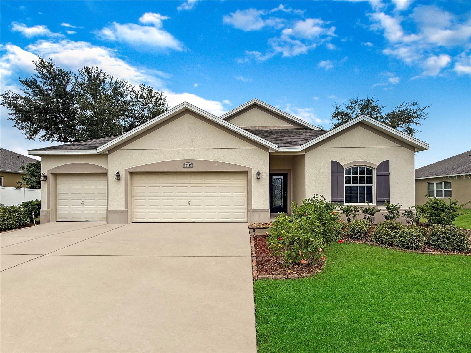 Discover your next opportunity in Hammock Pointe, Clermont! This 4-bedroom, 2-bath home with a 3-car garage sits on an oversized lot in one of Clermont’s most desirable natural gas communities. Offering 1,825 sq. ft. of bright, open living space, this residence was designed for effortless entertaining and everyday comfort. Step inside to find soaring 9’4” ceilings, a spacious family room that blends seamlessly into the dining area, and a kitchen ready for culinary creativity—complete with a gas range, microwave, dishwasher, generous pantry, and ample storage. The owner’s suite offers a private retreat with a walk-in closet featuring efficient shelving and a spa-inspired bath with a garden tub, separate shower, and raised vanities. Three additional bedrooms provide plenty of room for family, guests, or a home office. Enjoy the Florida lifestyle outdoors with a covered lanai, large patio, and community amenities including a resort-style pool, cabana, and tot lot. Ideally located near the Florida Turnpike, Hwy 27, Lake Minnehaha, Orlando Health South Lake Hospital, and downtown Clermont’s shopping, dining, and recreation—plus world-class golf and theme parks just 30 minutes away. Whether you’re looking for your next home or a prime investment, this property won’t stay on the market for long. Schedule your private showing today and experience all that Hammock Pointe has to offer!
