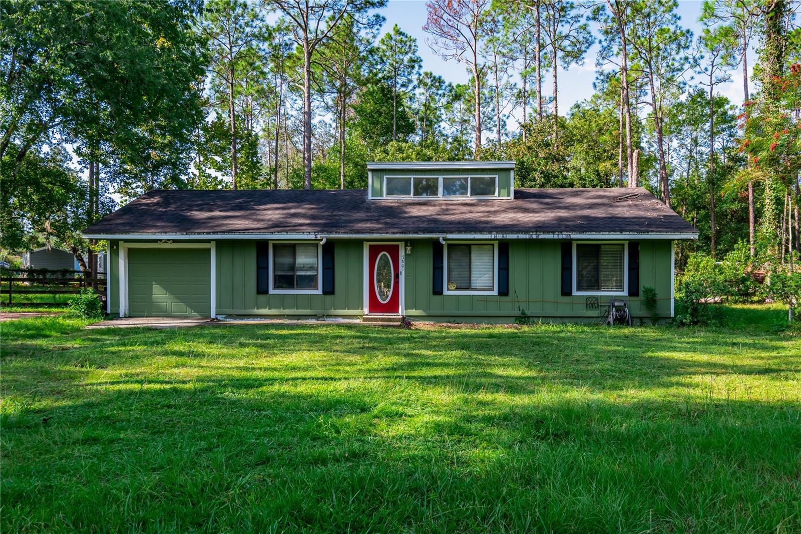 Welcome to Kanapaha Pines! This 3-bedroom, 2-bathroom home offers 1,092 square feet of living space on a one-acre lot. Step inside to a light-filled living and dining room combination with vaulted ceilings and French doors that open to the backyard. The kitchen features granite countertops and connects to a hallway with washer and dryer, leading to the one-car garage. The primary bedroom has a walk-in closet, and a private bath with a tub/shower combination. Two additional bedrooms are located on the opposite side of the home and share a full bathroom. Vinyl plank throughout, no carpet! The backyard is fully fenced, offering space for pets, gardening or play. Conveniently located just off Archer Road with easy access to I-75, Butler Plaza and Celebration Pointe shopping and dining.
