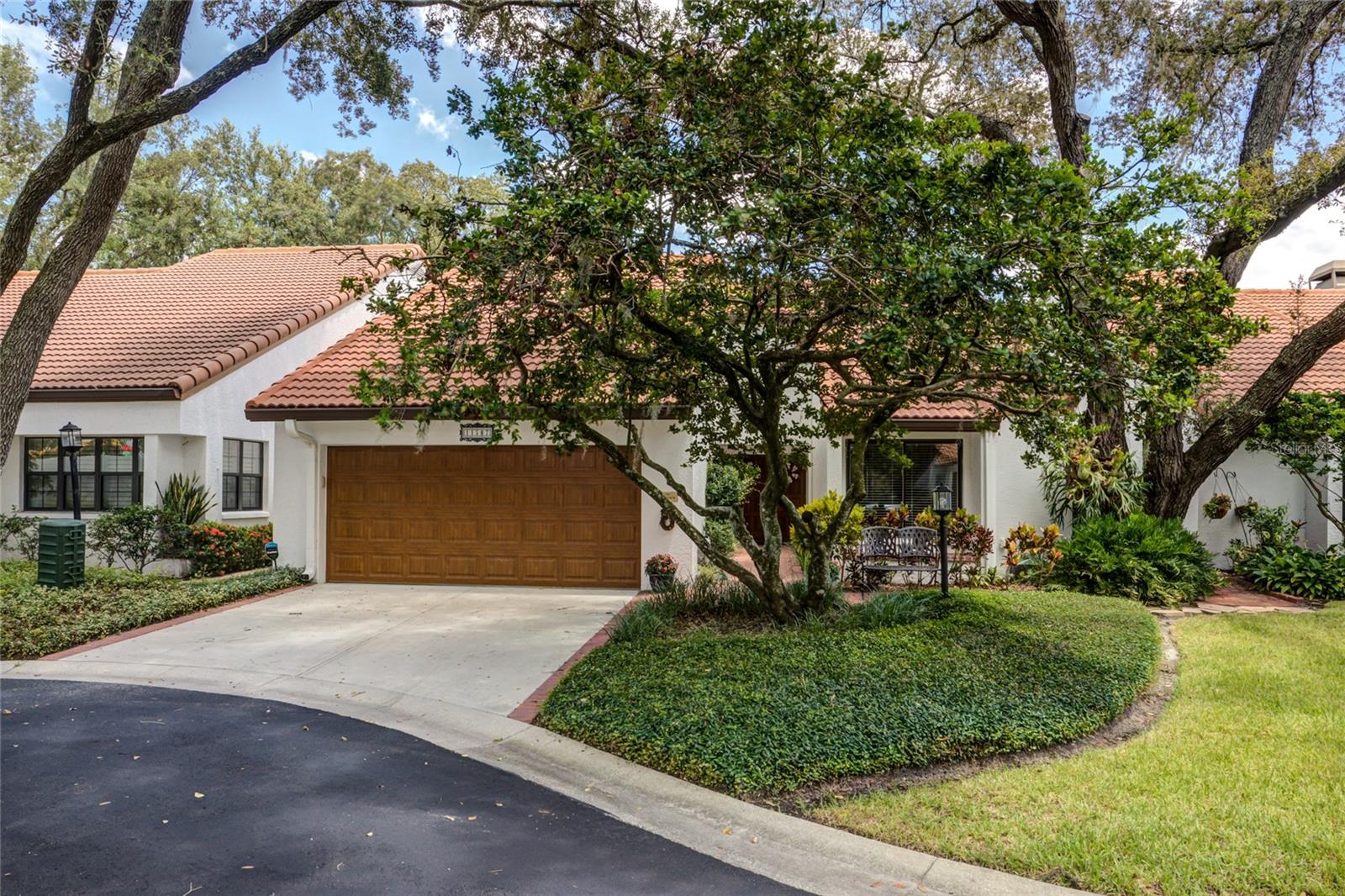 Welcome to your charming retreat in a secure, amenity-rich community designed for those who want to stay active, social, and relaxed. Nestled on a quiet cul-de-sac, this beautifully maintained home offers both privacy and connection, and resort-style amenities. This home blends comfort with thoughtful design. A fully gated and walled garden with brick-paved walkways creates a serene, private outdoor oasis, enhanced by bright evening lighting. Step through the double-door entry into a soaring living room with ambient plant-shelf lighting and a triple collapsible slider that opens to the screened lanai. Entertain in the formal dining and sitting rooms, or prepare meals in the updated kitchen featuring white quartz countertops, lazy Susan's, pull-out shelving, and a charming planter window for fresh herbs. The split bedroom layout includes a guest suite at the front of the home, while the spacious master retreat offers lanai access, dual closets, and a private bath with separate vanity and shower areas. An additional office/den with a walk-in closet provides flexibility for a third bedroom. The oversized garage and attic storage keep everything organized, and with yard and street maintenance included in the HOA, you’ll have more time to enjoy life. If you do want to get out and enjoy the Florida sunshine, you do not even have to leave the community. The gated community amenity area has scenic paved trails winding through lush green spaces, dotted with benches perfect for lingering conversations. Meet friends at the pool and jacuzzi, complete with bathrooms, showers, and a spacious deck for community events. Enjoy tennis or pickleball, unwind in the gazebo overlooking the river, or store your recreation vehicle in the dedicated storage area before heading out on your next adventure. If you’re ready for a vibrant yet peaceful lifestyle in a tight-knit community that feels like home, this property delivers it all.