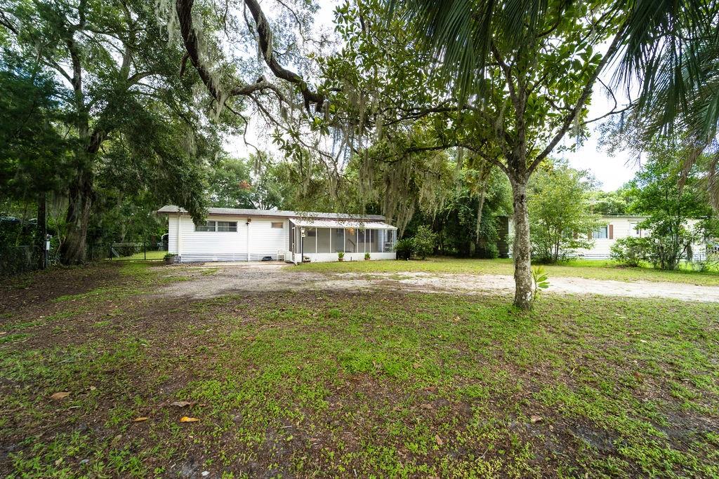 This move-in ready 3-bedroom mobile home sits on a spacious 0.30-acre lot with NO HOA, NO lot rent, and NOT in a mobile home park—just freedom and space! Offering 1,300 sq ft of living space, this home has been updated throughout with new laminate wood flooring, new front door, new electrical panel and wiring, new well equipment, new water filtration system, and new plumbing in the kitchen and bath. Enjoy the open front porch, a large living room open to the kitchen, and a separate dining room—great for entertaining. The fully fenced backyard includes a large workshop with electric and water—perfect for hobbies, storage, or home projects—as well as a utility shed/pump house. This is a solid opportunity for investors, snowbirds, or anyone looking for affordable living with space to grow. This one won’t last long!
